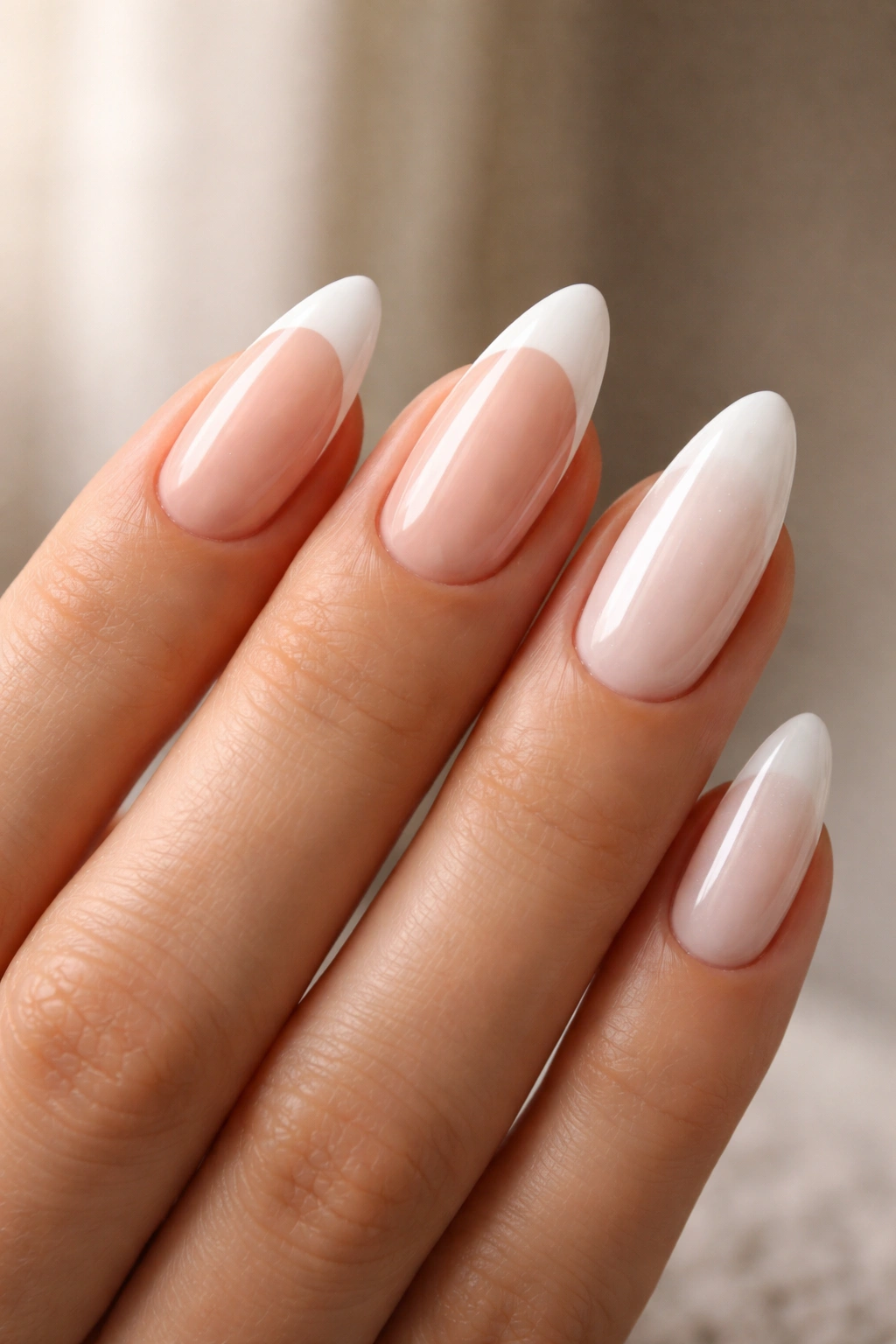 Hand showing three almond nails with varied white tips to illustrate choices.