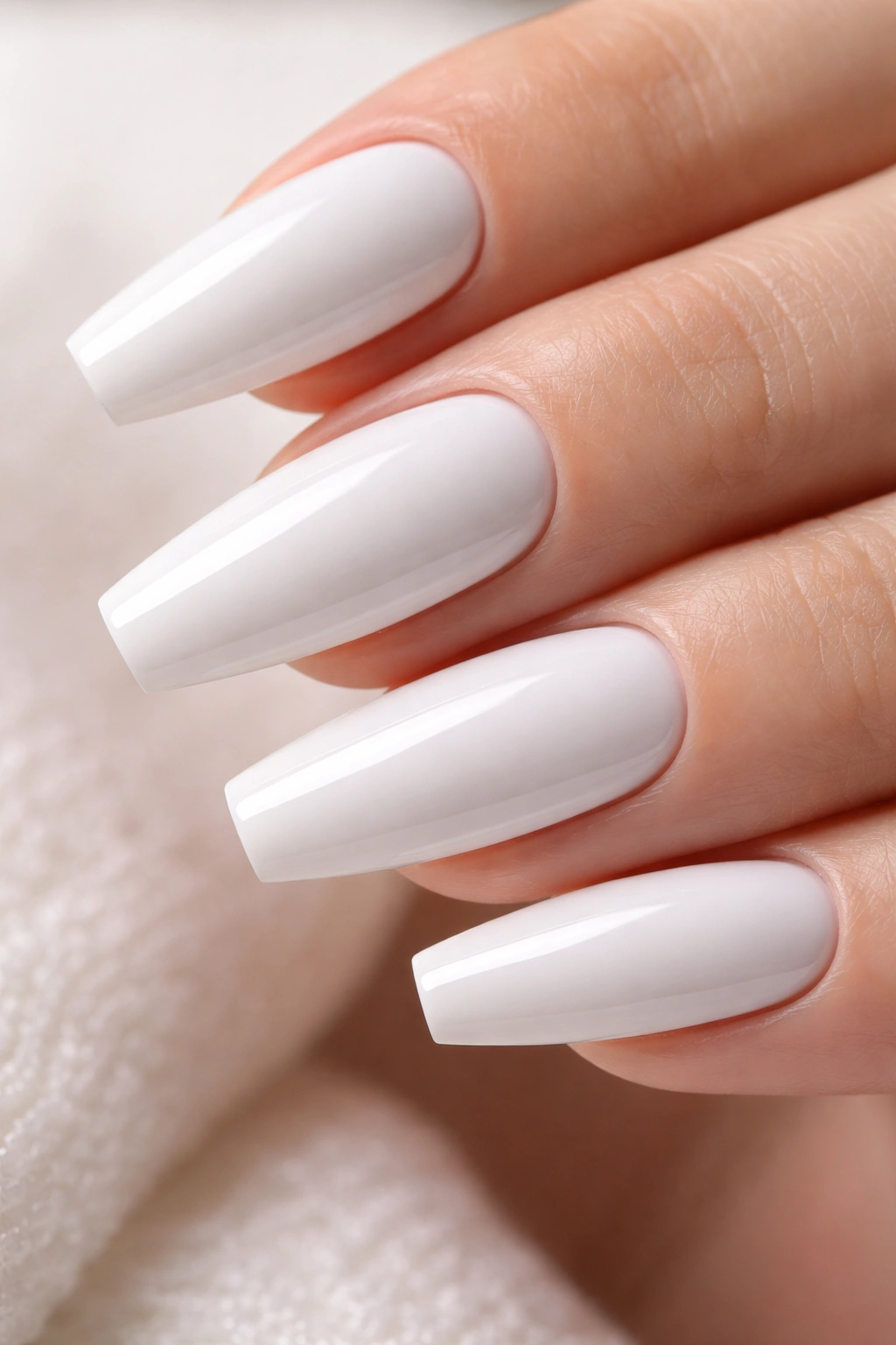 Close-up of clean white gel nails showing a flawless surface
