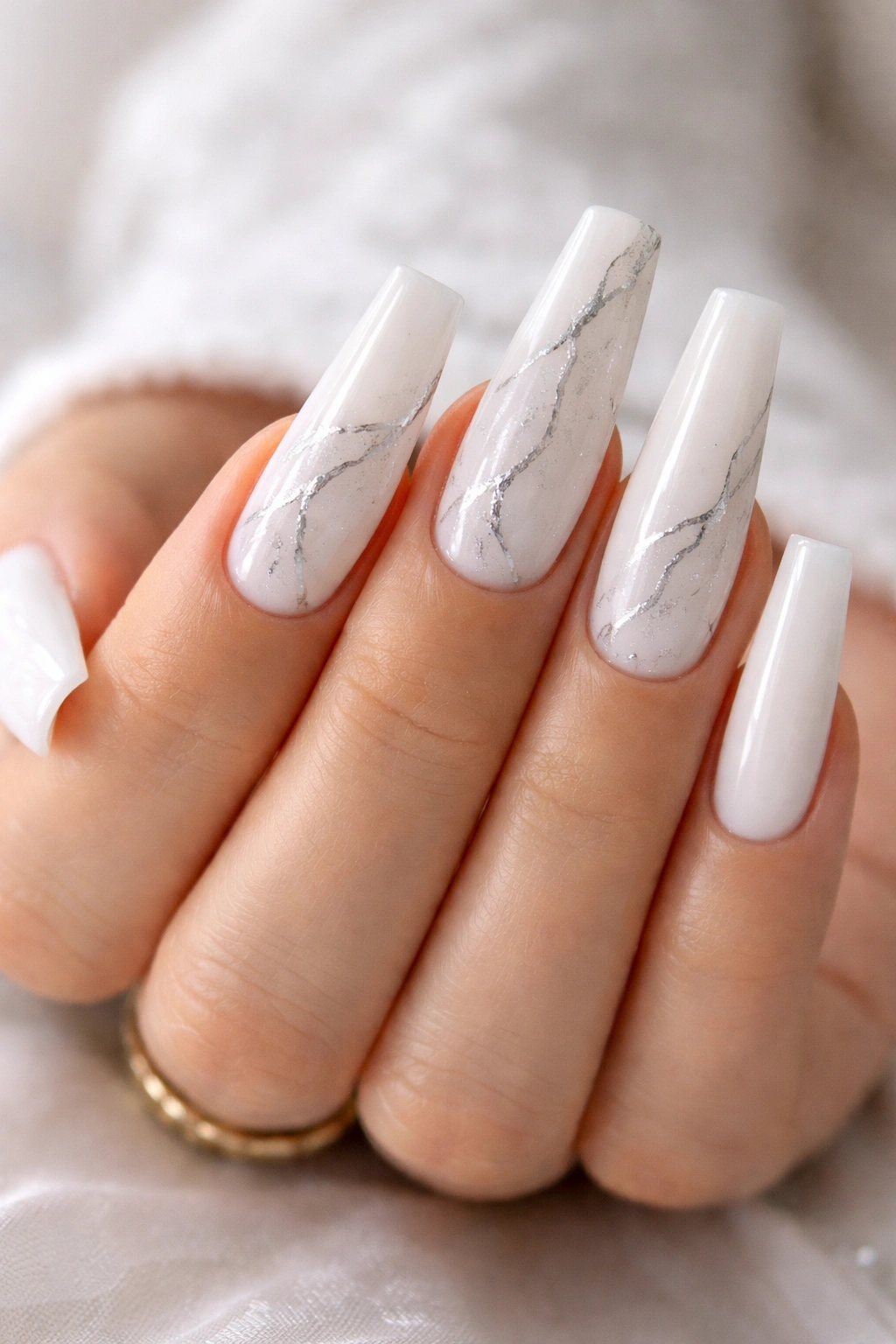 White marble nails with fine gray veins and silver accents