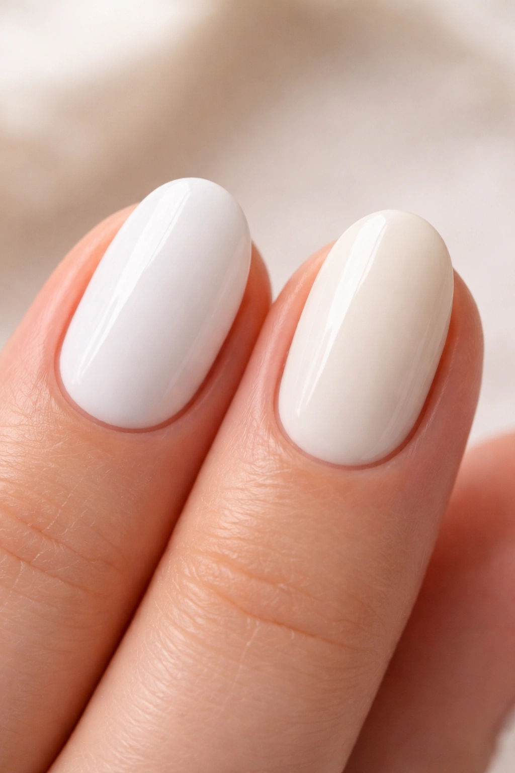 Two white short oval nails showing subtle shade differences