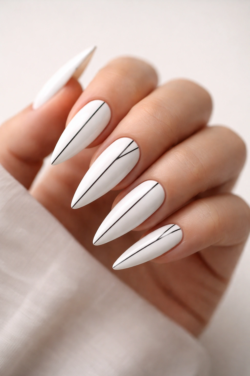 Close-up of white nails with thin black line details