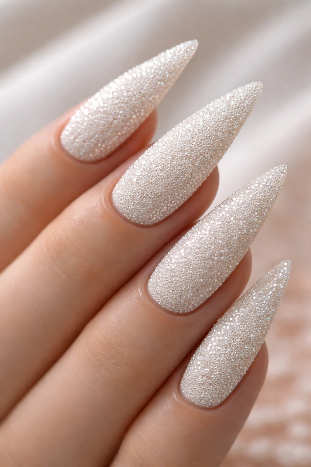 Close-up of white nails with caviar bead texture
