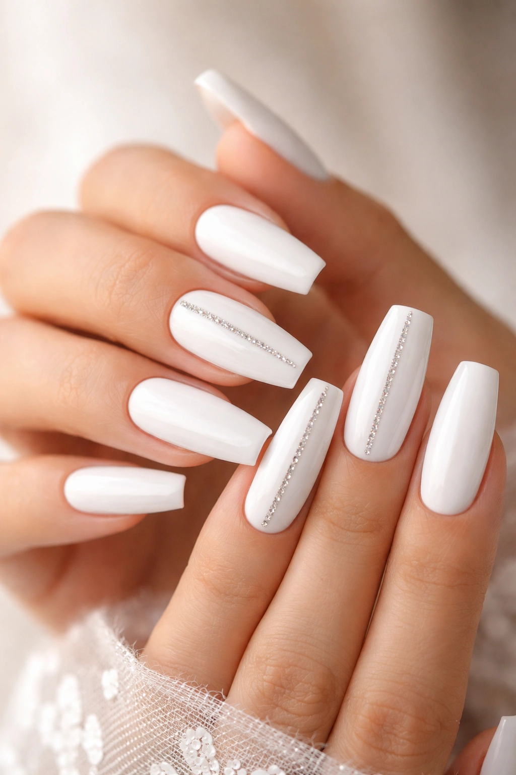 White coffin nails with a slim central line of tiny diamonds on accent nails