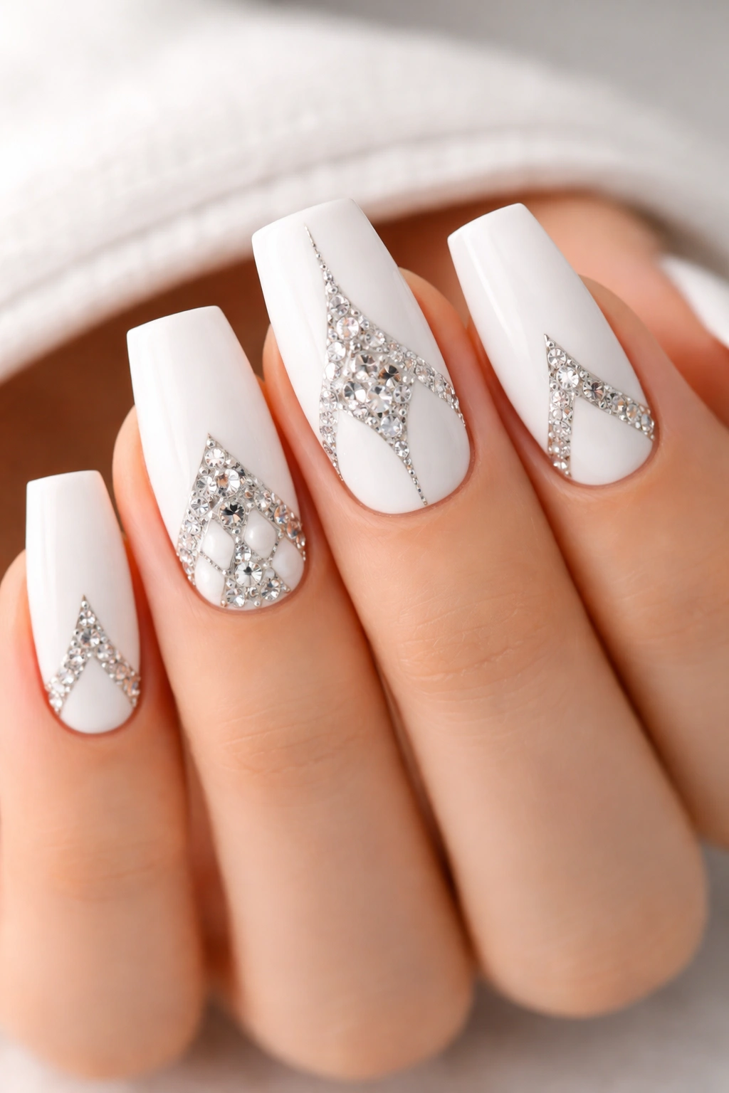 White coffin nails with geometric rhinestones forming triangles squares hexagons