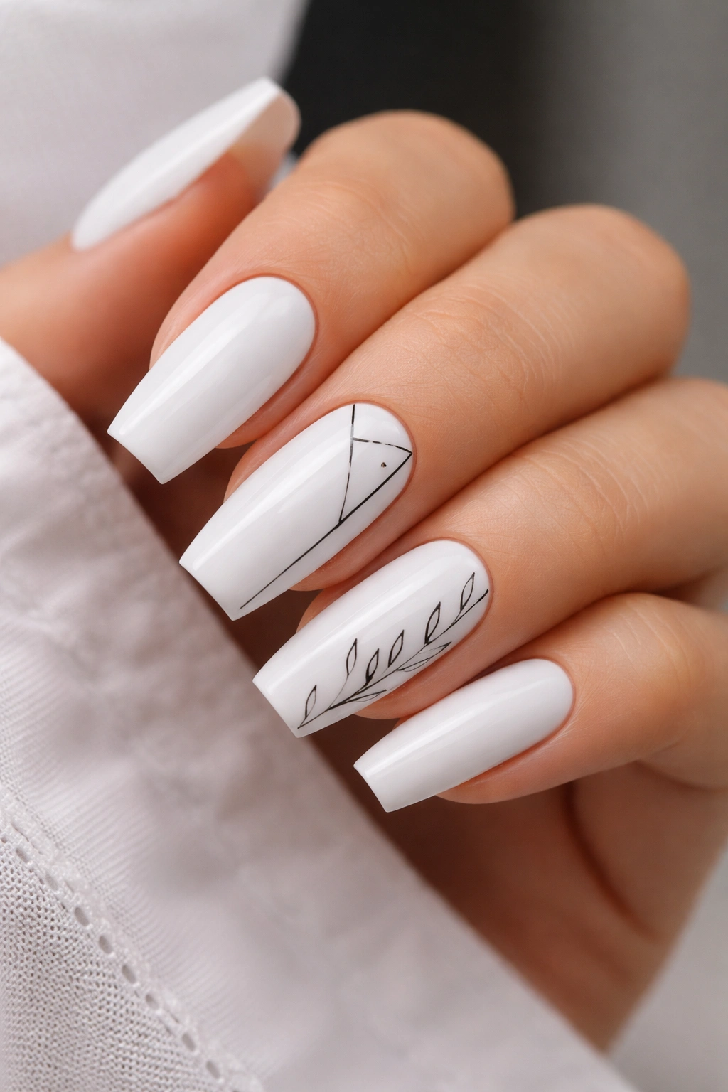 White coffin nails with black line art patterns