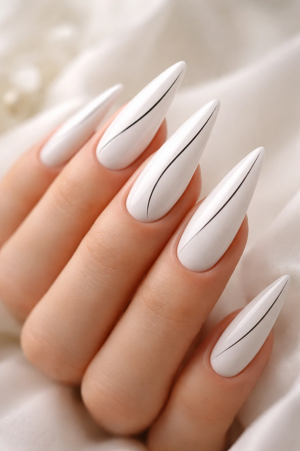 Close-up of white nails with thin black line art