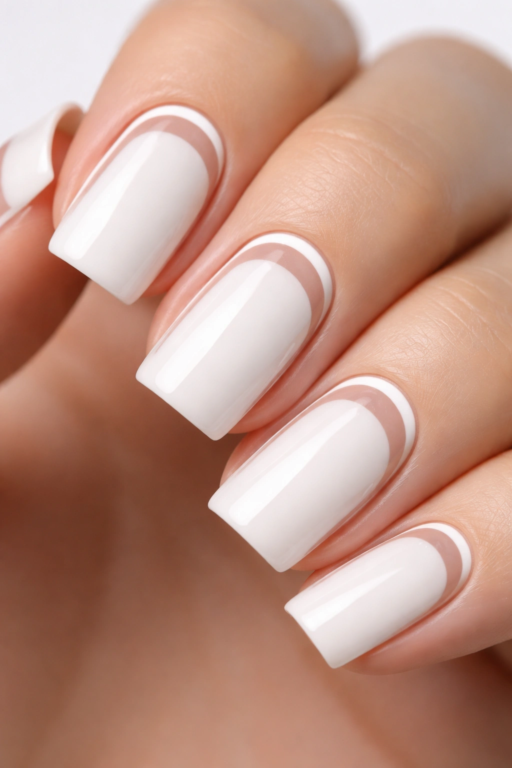 Close-up of white nail with a negative space accent strip on a neutral background.