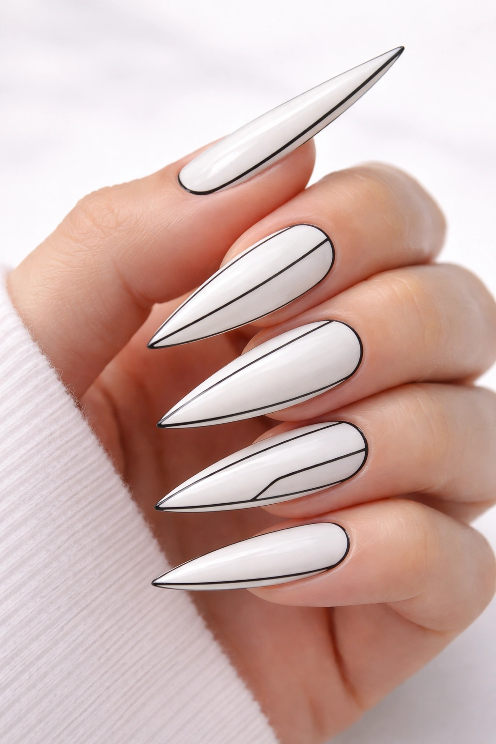 White stiletto nails with thin black outline details