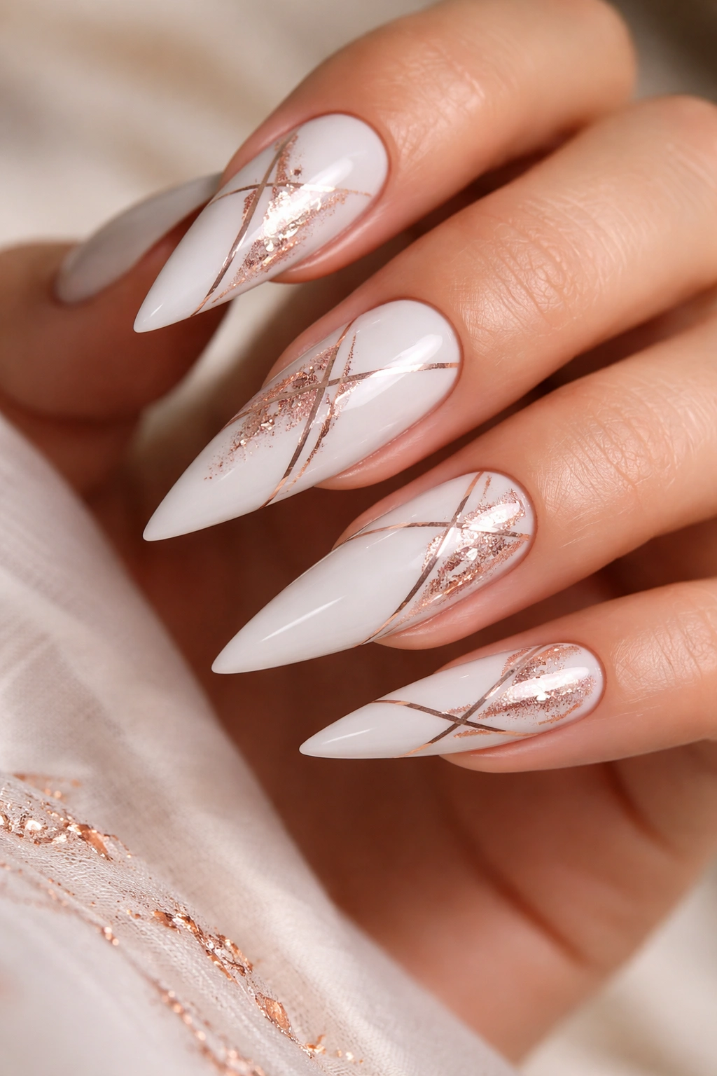 Close-up of white nails with rose gold accents