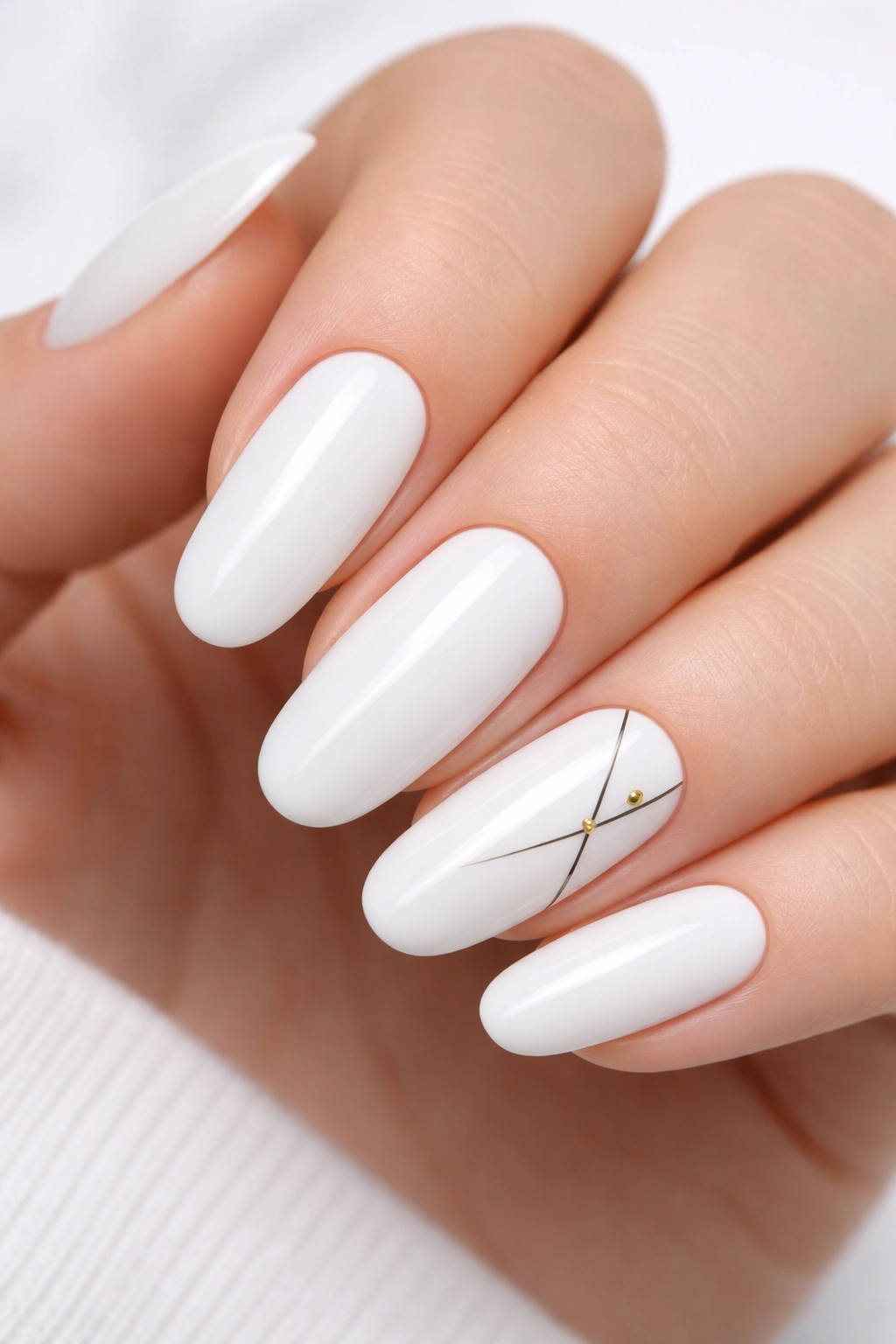 Close-up of white long round acrylic nails with subtle geometric art on one accent nail