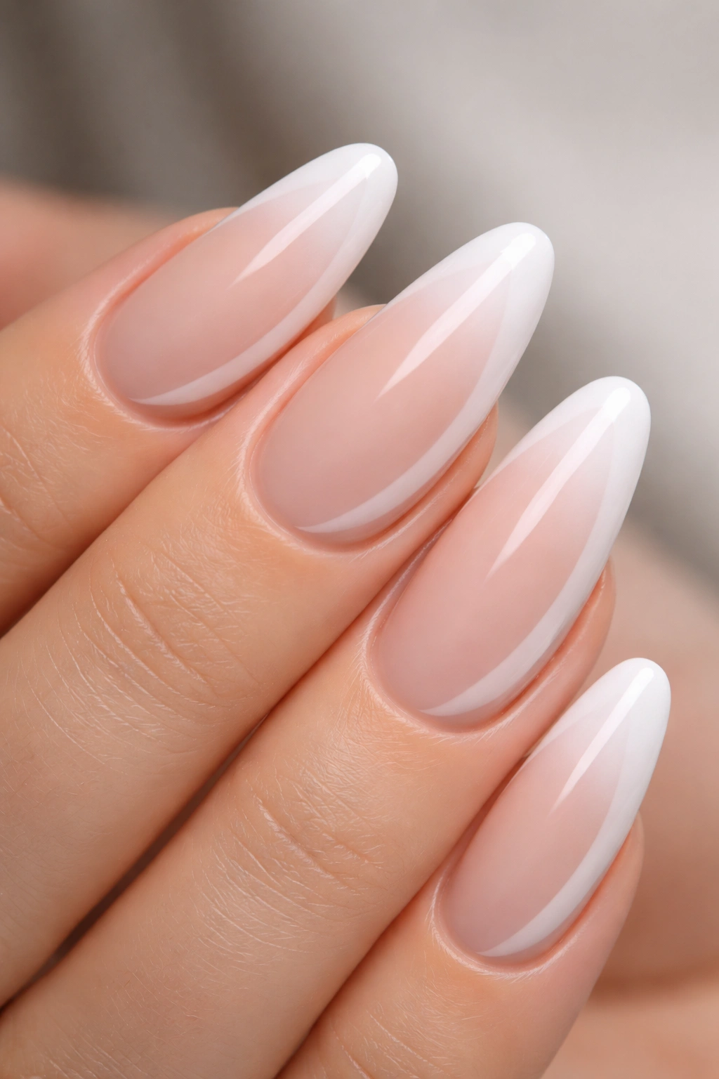 Close-up of nails with white to nude ombre side French gradient