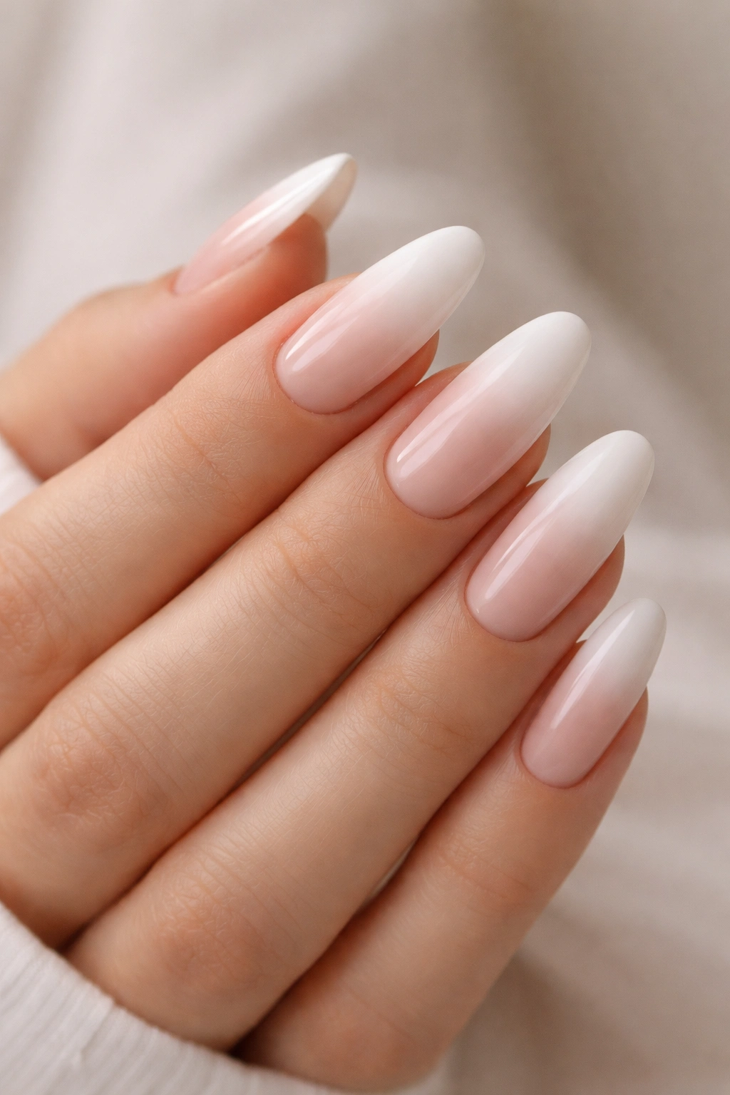 White ombre on long oval nails blending nude to white