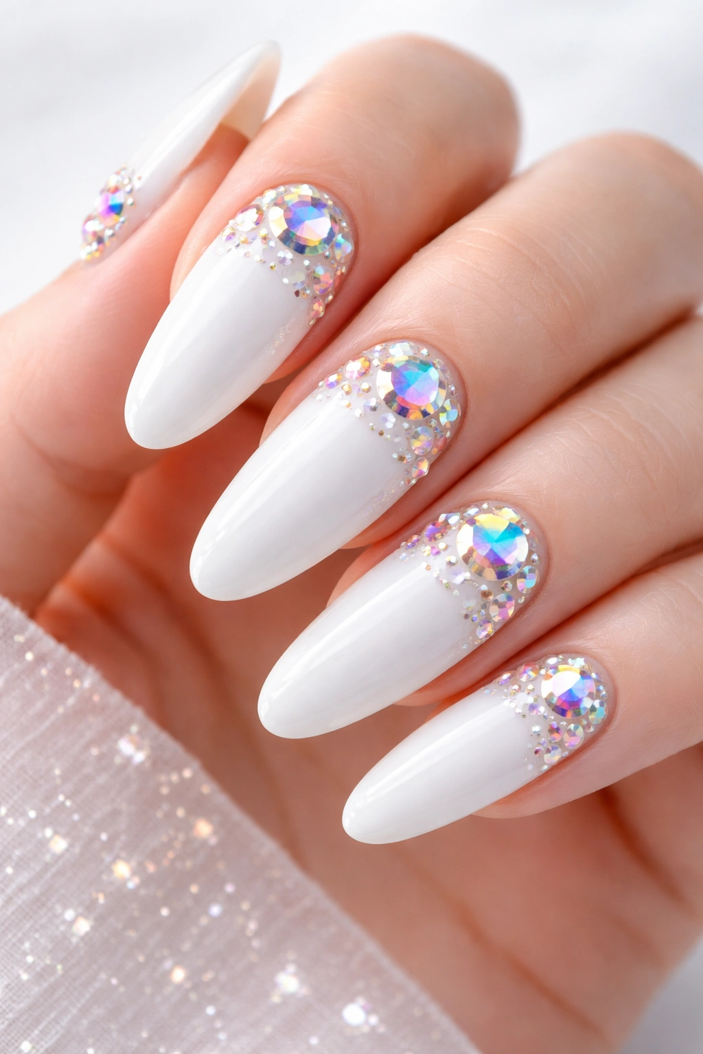 Close-up of long white-oval nails with rainbow iridescent crystals on eggshell finish