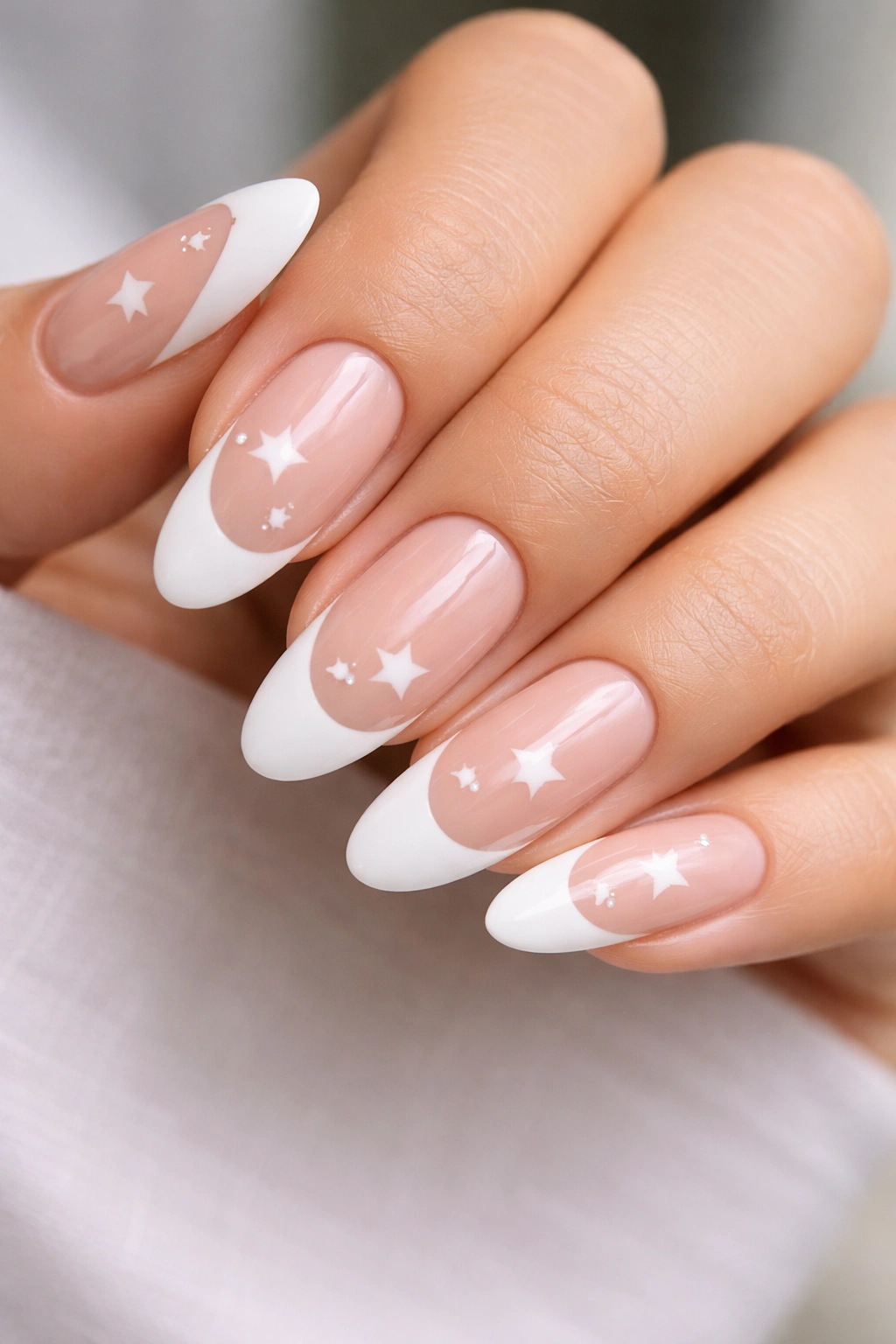 Long oval nails with white tips and negative-space star shapes