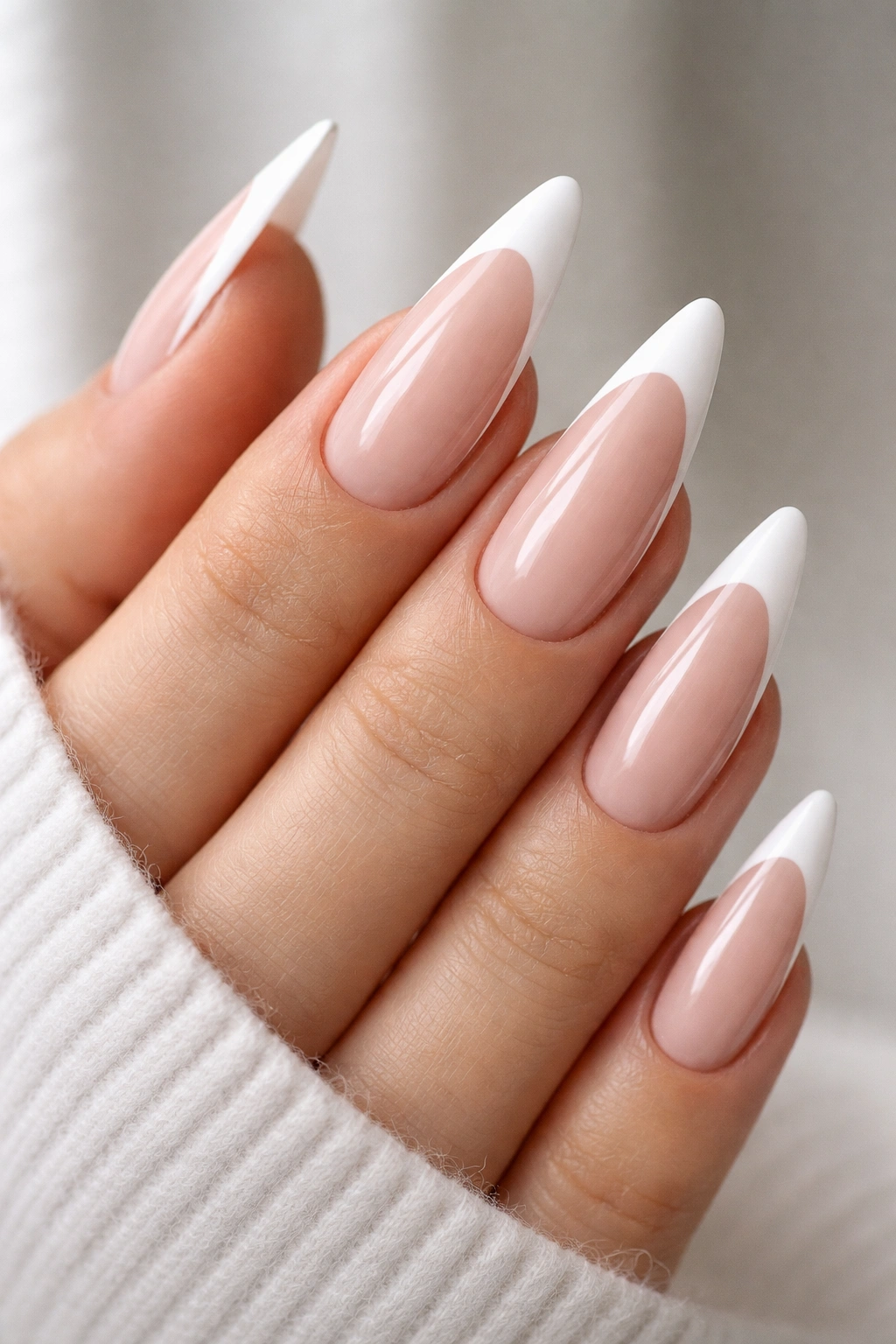 Close-up of almond nails with tapered sidewalls and white French tips
