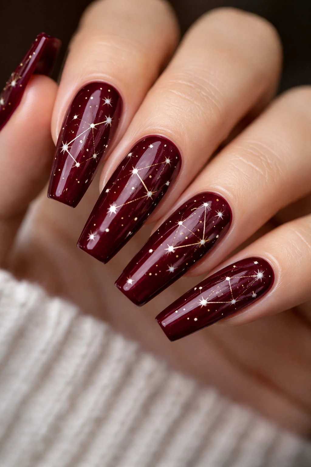 Wine red coffin nails with delicate constellation dots and lines.