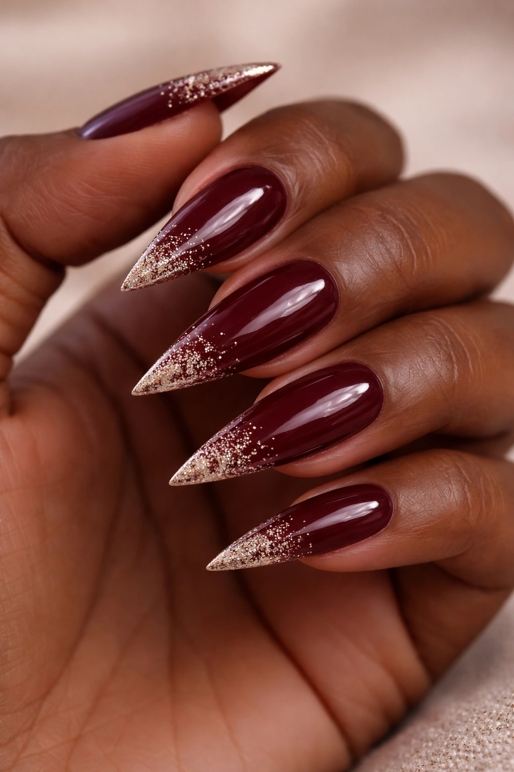 Wine red stiletto nails with glitter tips