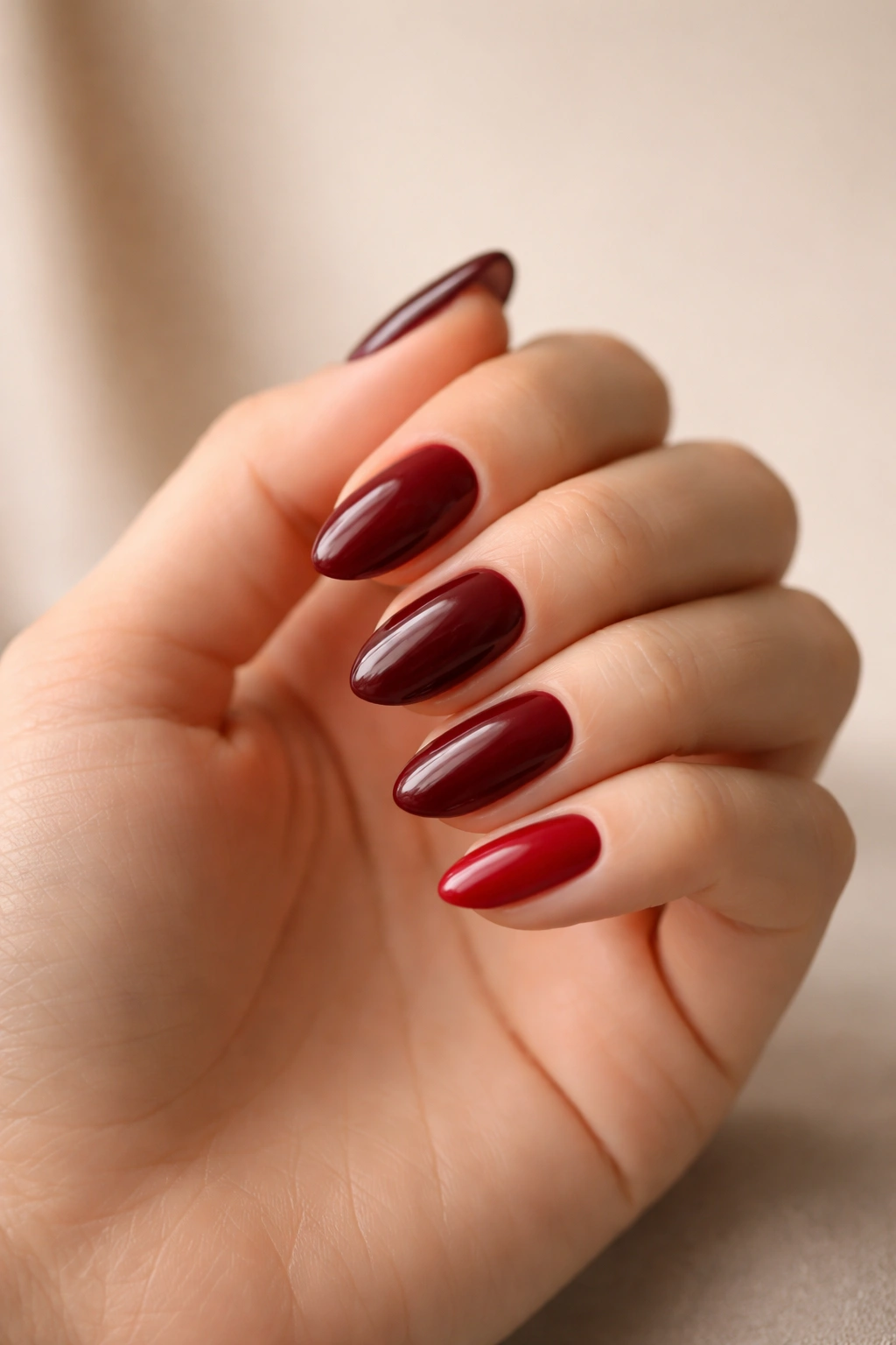 Hand showing wine red nail color undertones for skin tone matching