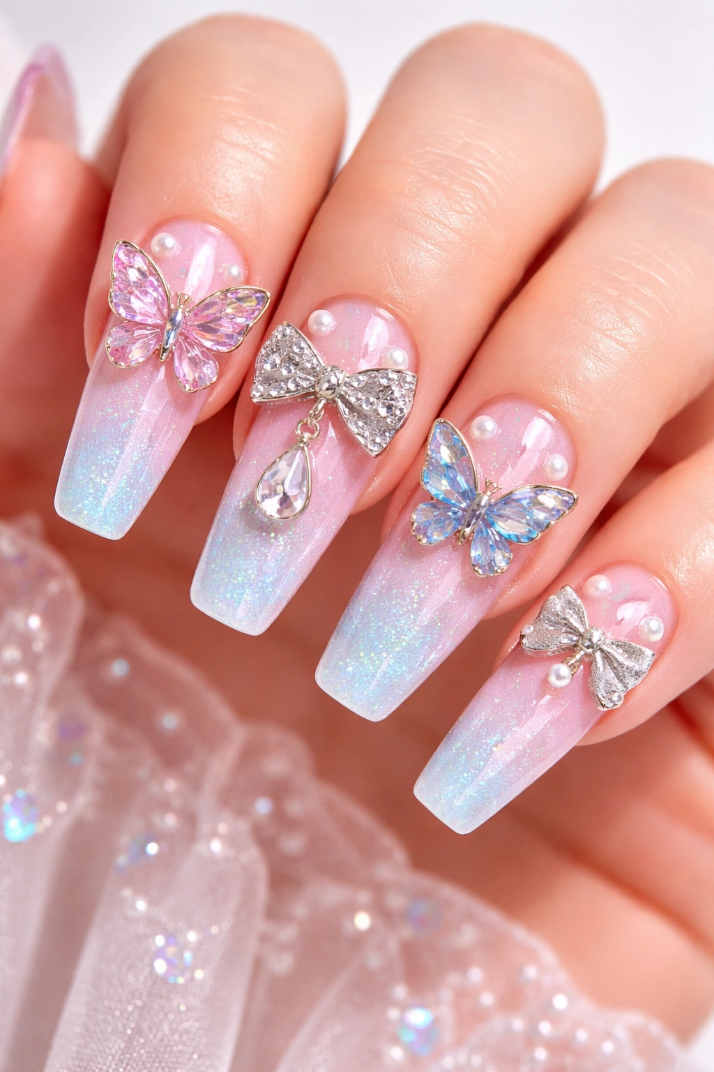 Nails with butterfly and bow charms on pastel ombre nails