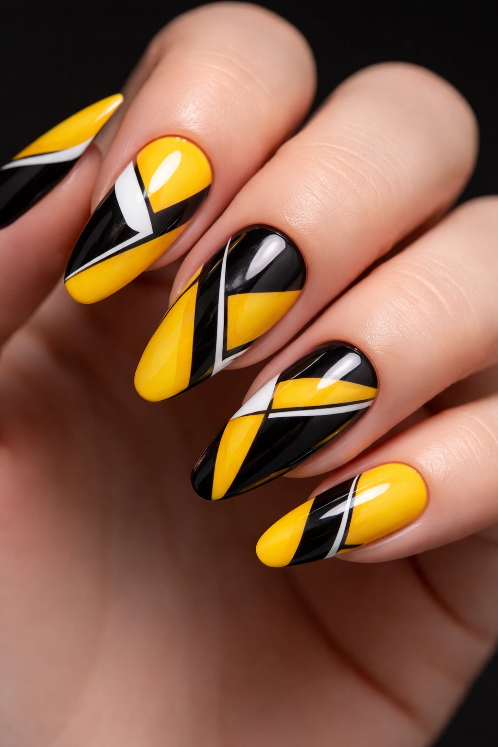 Nails with bold yellow and black geometric patterns