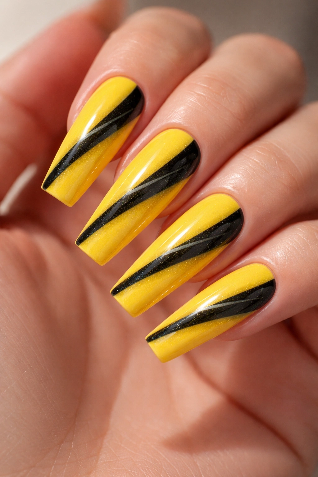 Coffin nails in sunshine yellow with a black cat-eye stripe