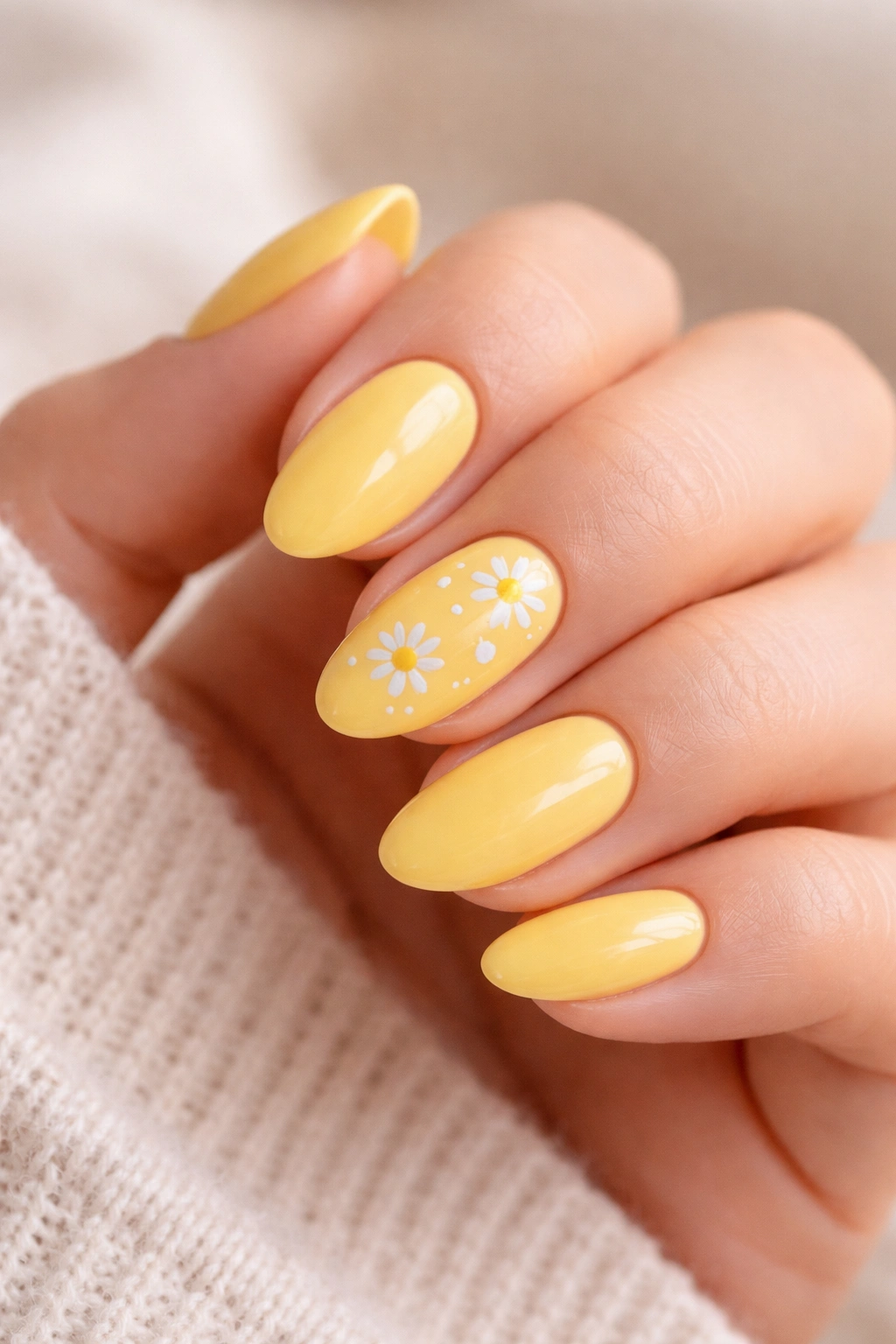 Yellow nails with tiny white daisies on short almond nails