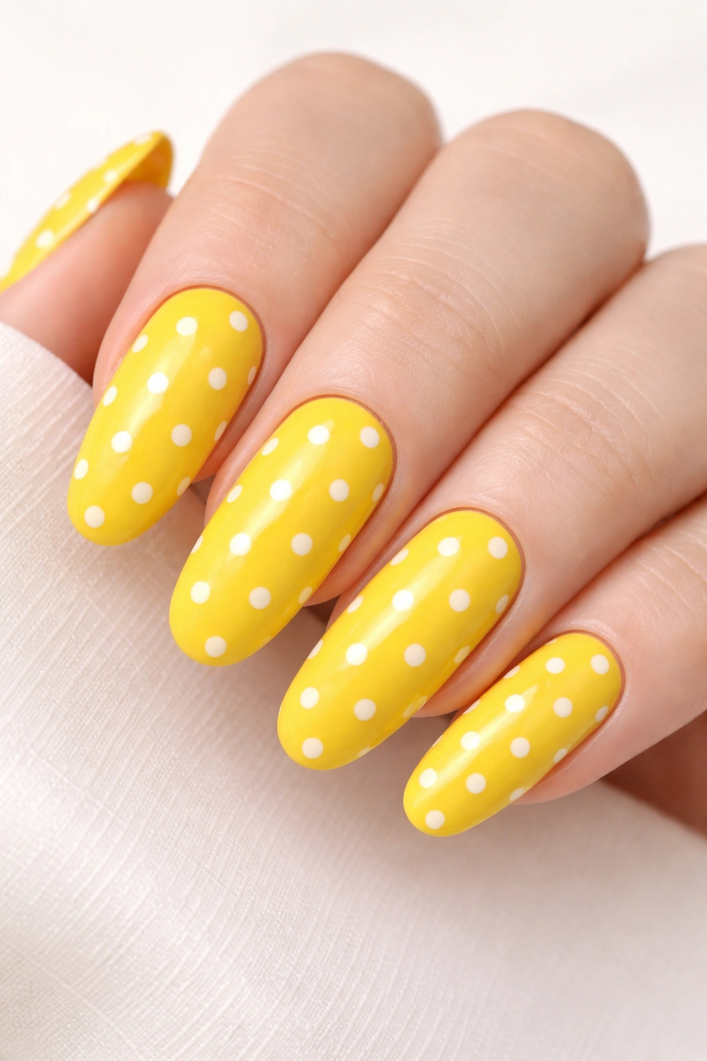 Sunny yellow nails with white polka dots