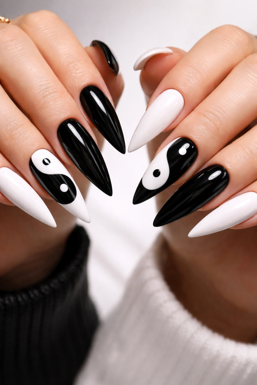 Long black and white nails with yin-yang symbol on ring finger