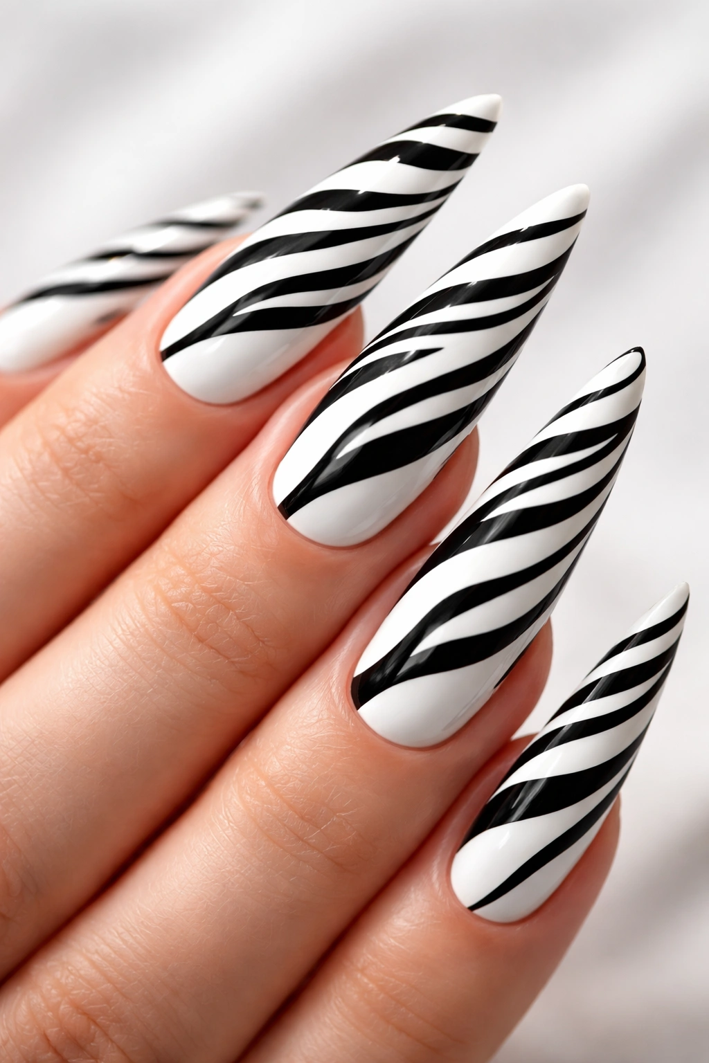 White stiletto nails with black zebra stripes