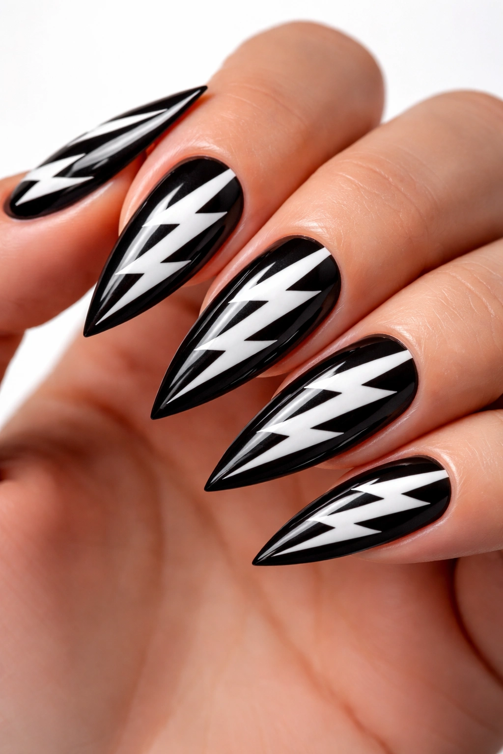 Close-up of nails with black base and white zigzag bolts