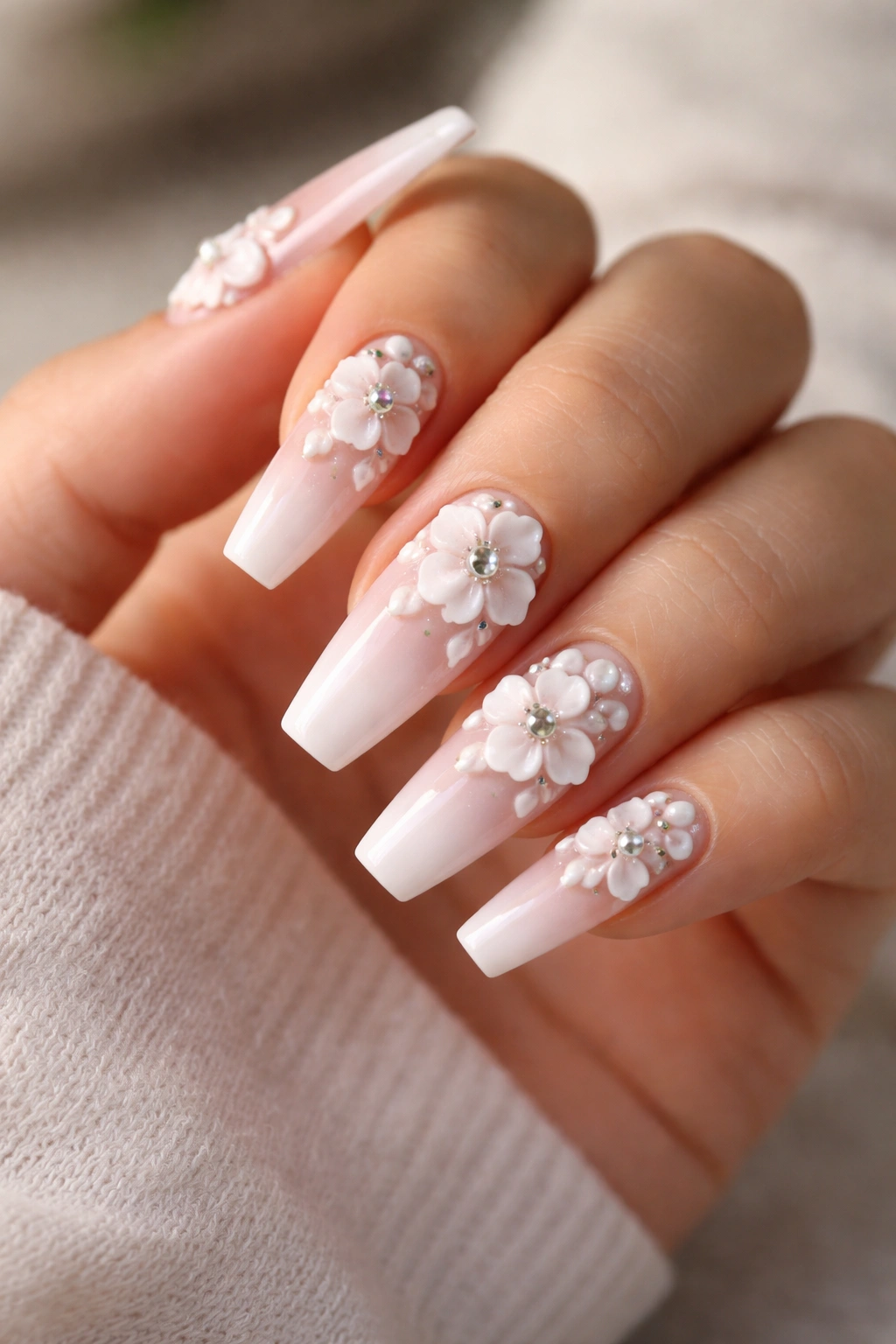 Close-up of 3D flower coffin nails with raised petals and pearl centers