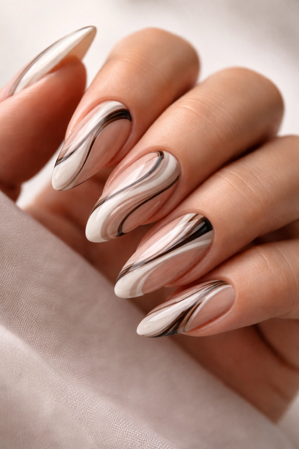 Close-up of abstract swirl almond nails on gel extensions