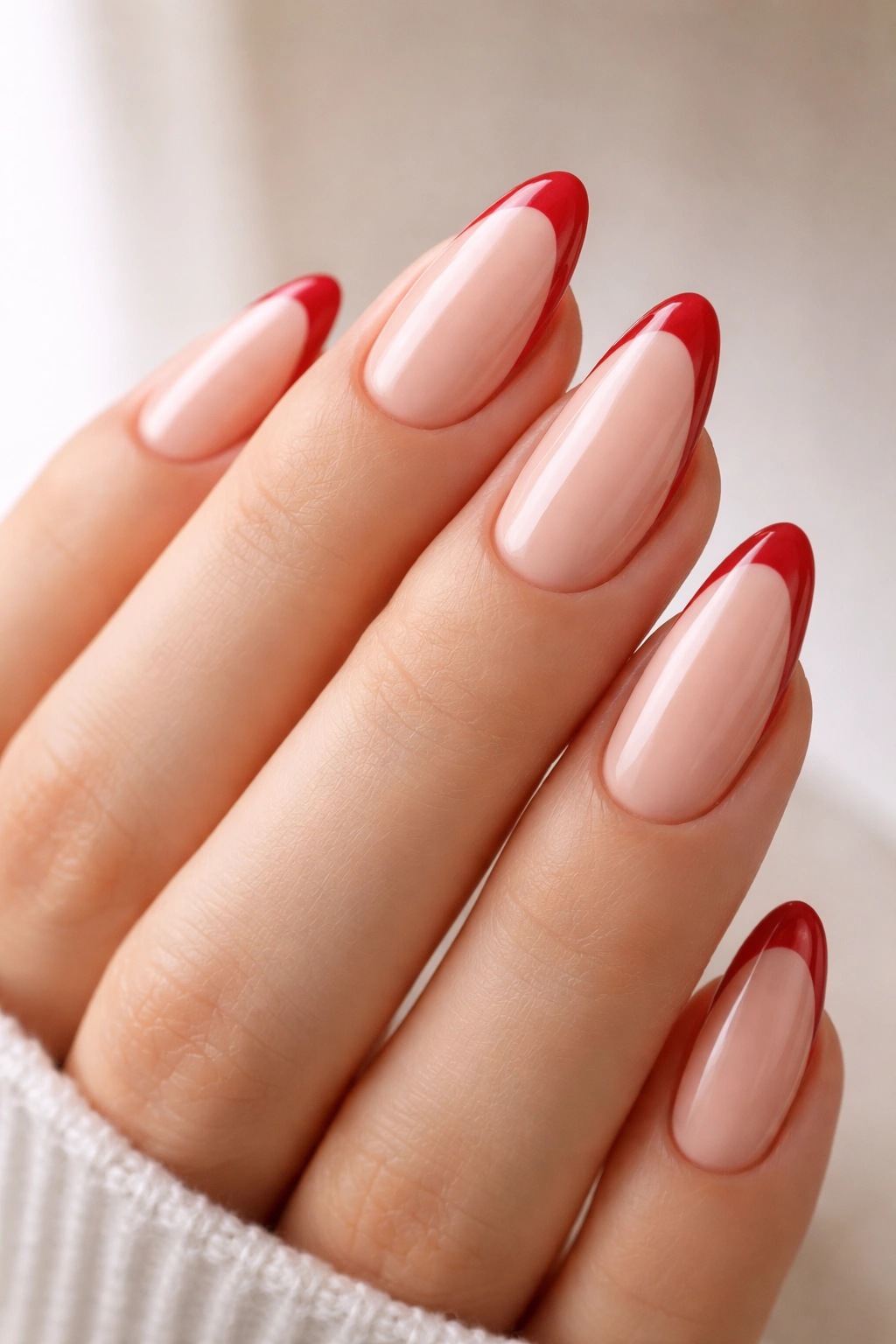 Almond nails with cherry red French tips on nude base