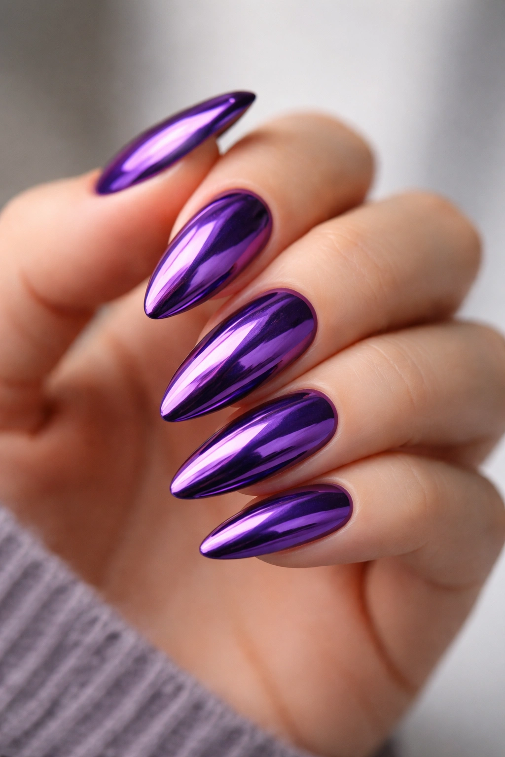 Almond nails in royal violet chrome with reflective finish.