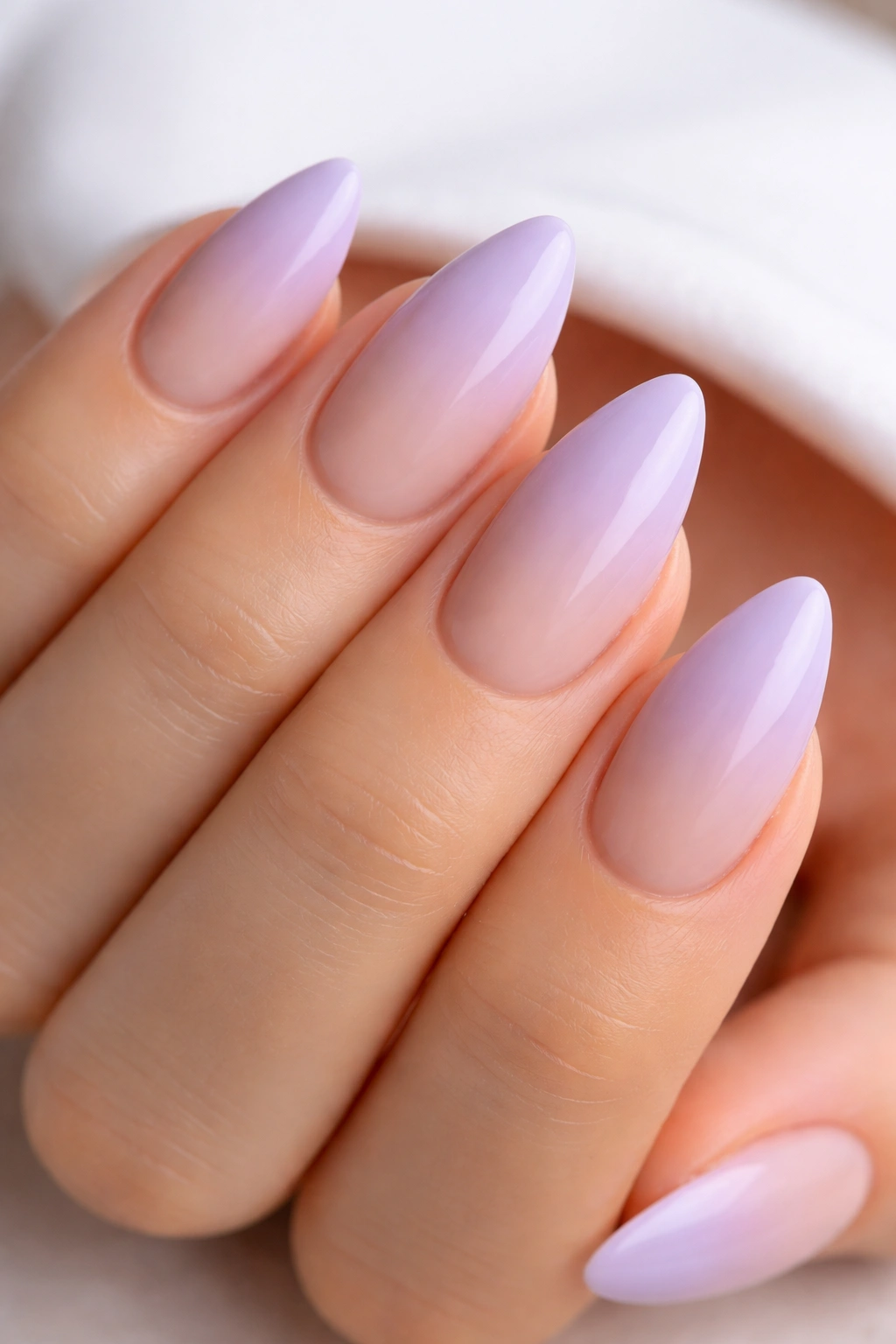 Almond nails with lavender ombré fading into nude
