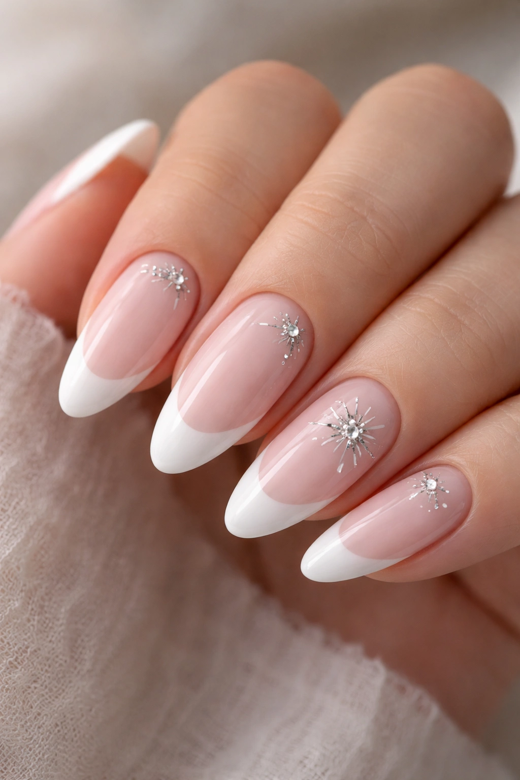 Almond nails with milky tips and silver starbursts
