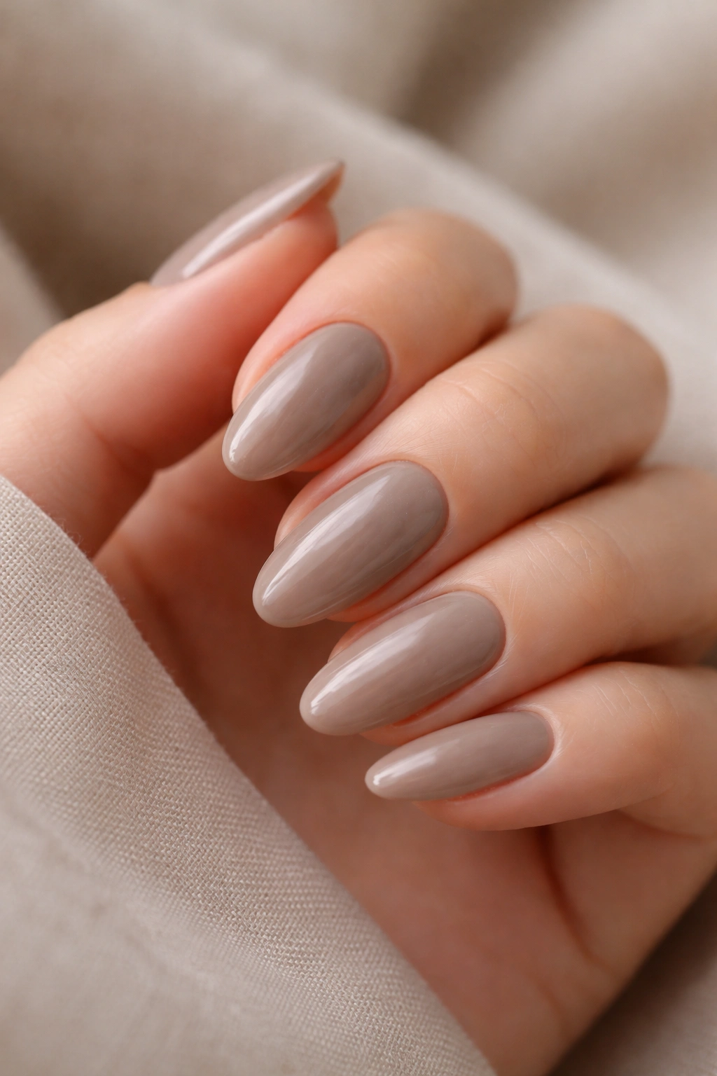 Mushroom taupe almond nails with sheer depth and gloss