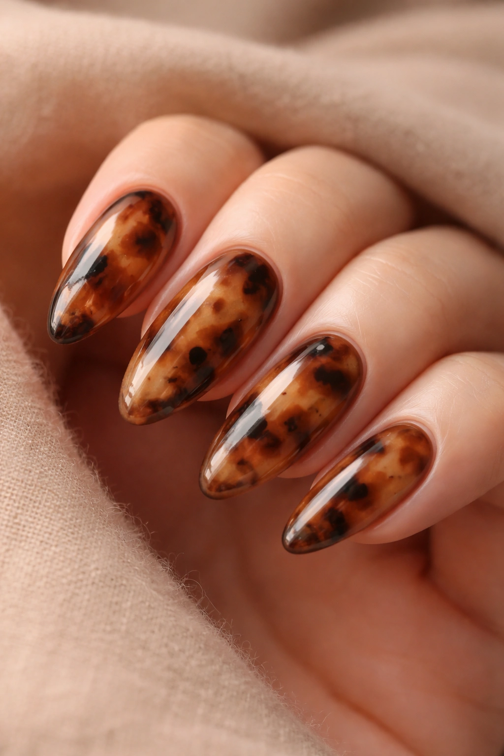 Almond nails tortoiseshell pattern in mocha tones