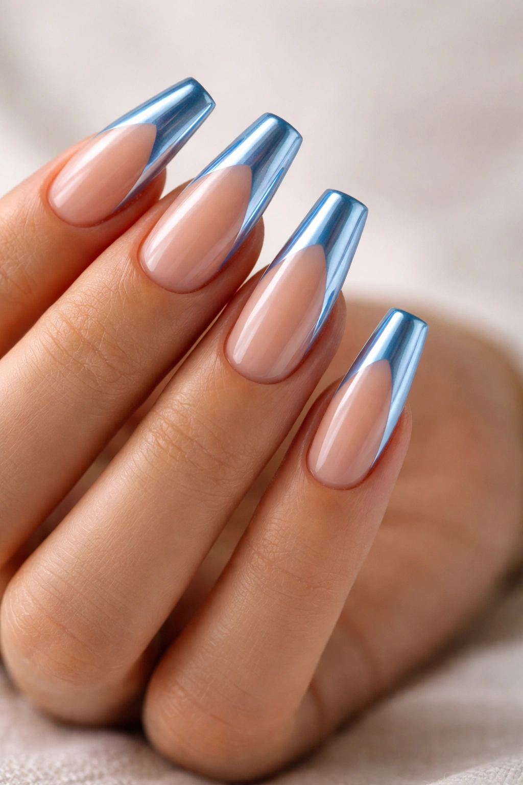Close-up of Baby Blue Chrome French Tips on Long Coffin Nails with nude base and blue chrome tips