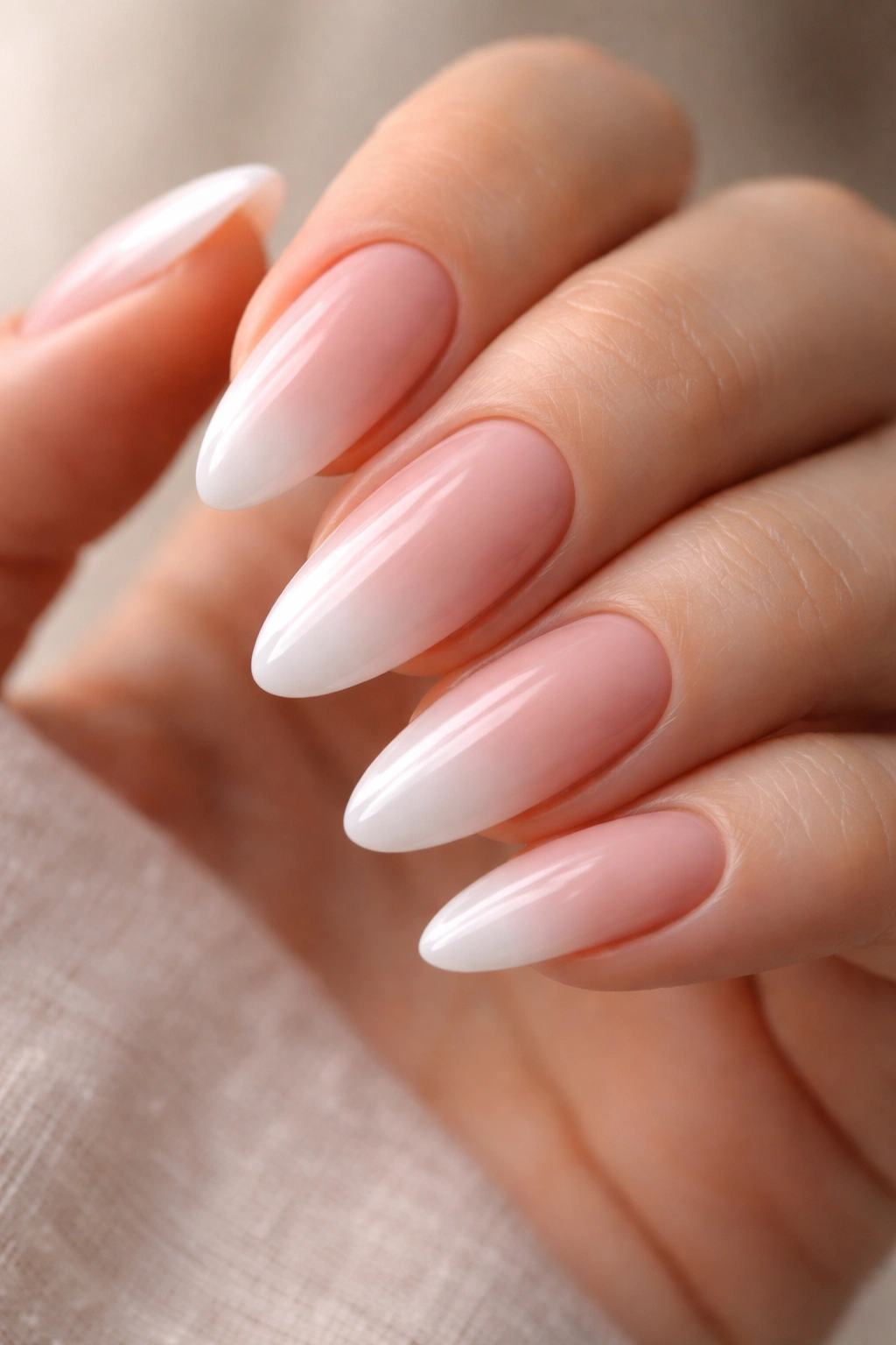 Close-up of baby boomer ombre almond nails on gel extensions