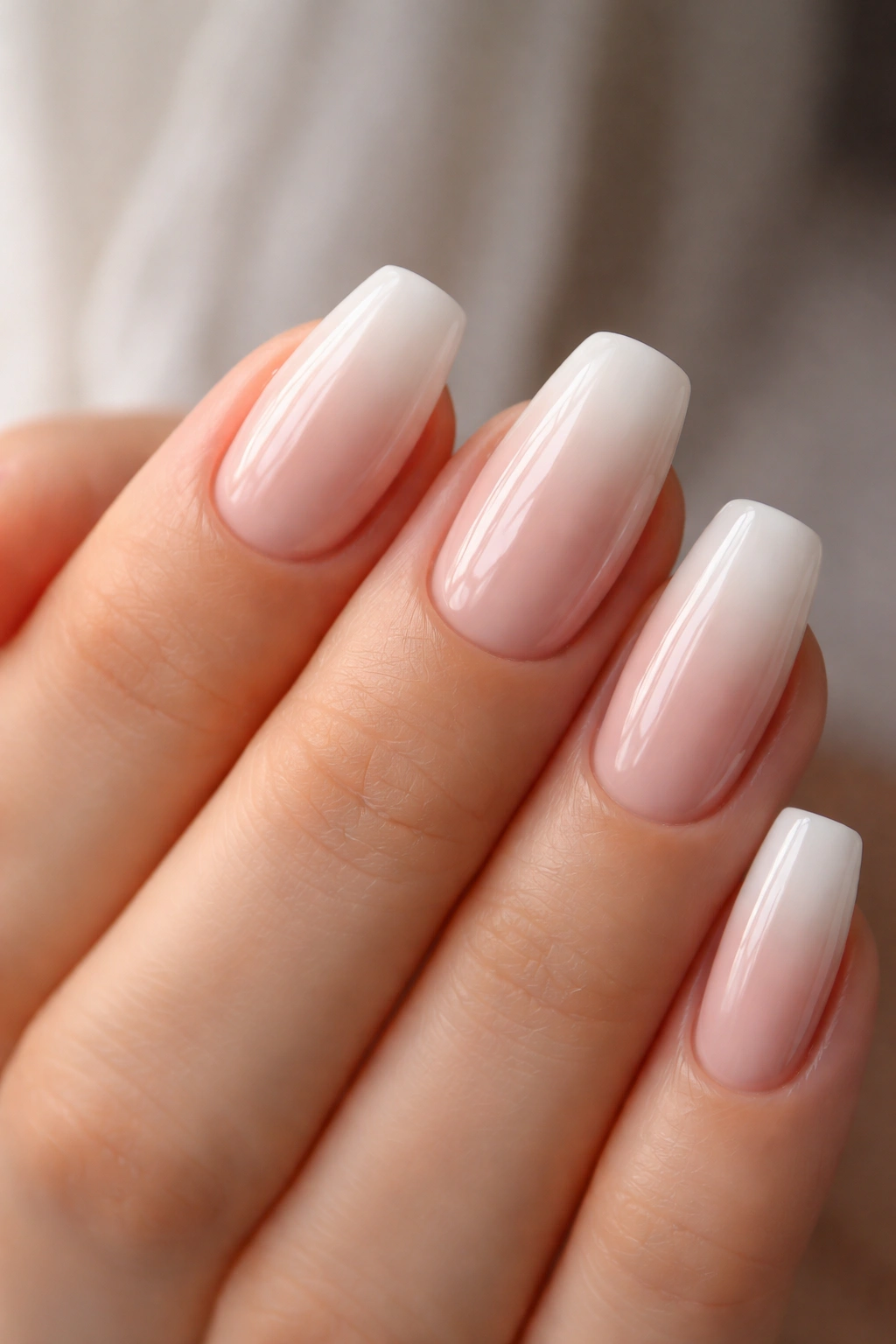 Close-up of baby boomer ombre coffin nails on short nails