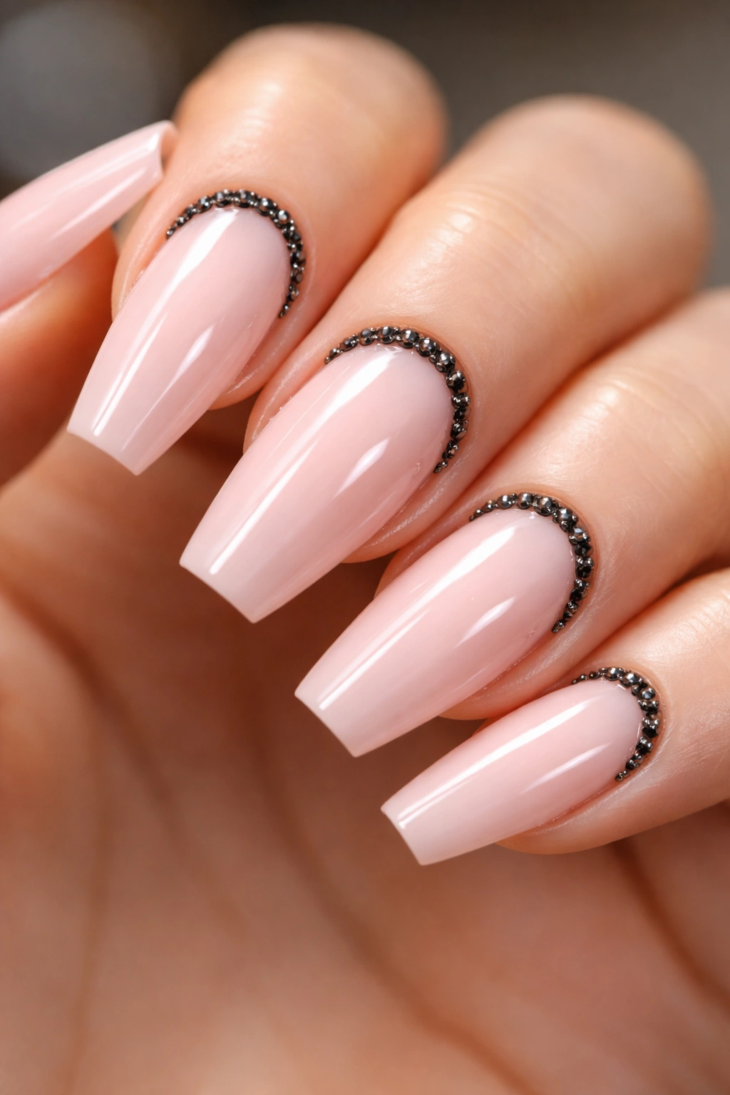 Coffin nails with ballet pink base and black crystal cuticle lines.