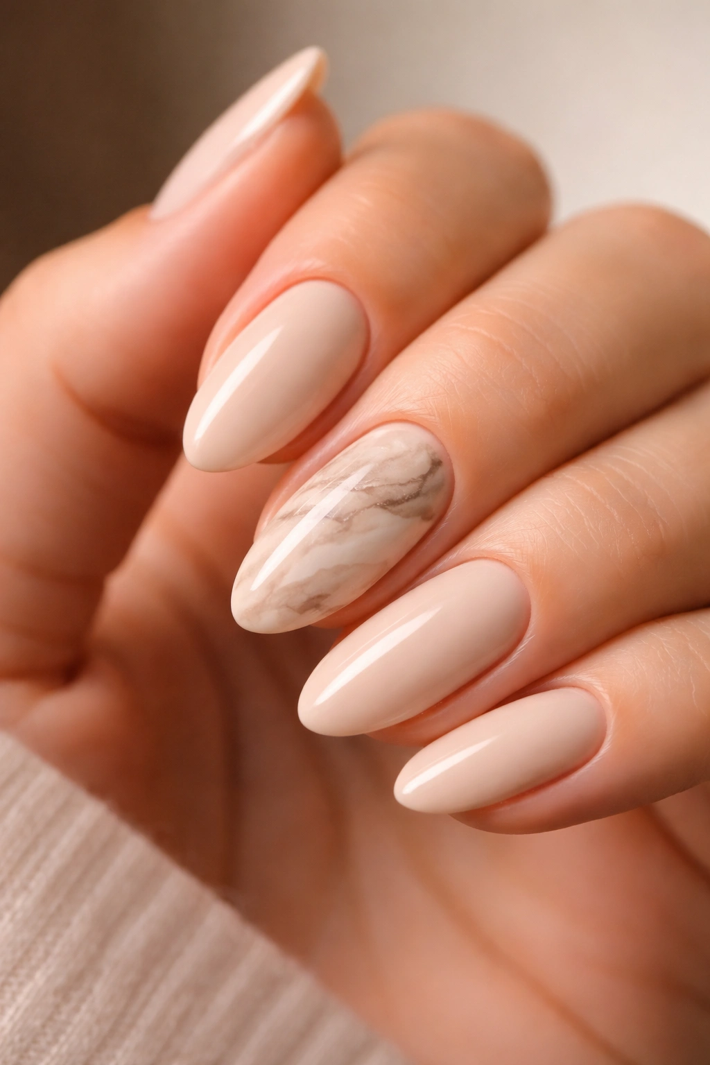 Beige marble accent nail on almond shape