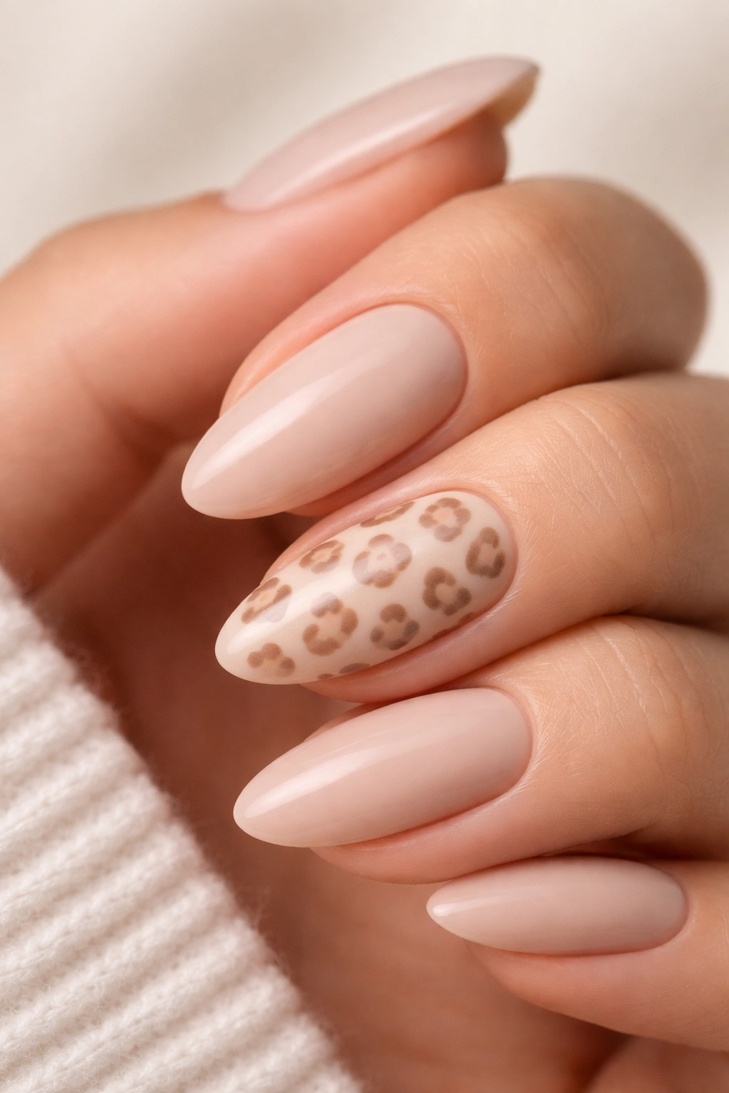Beige almond nail with a subtle caramel leopard print accent