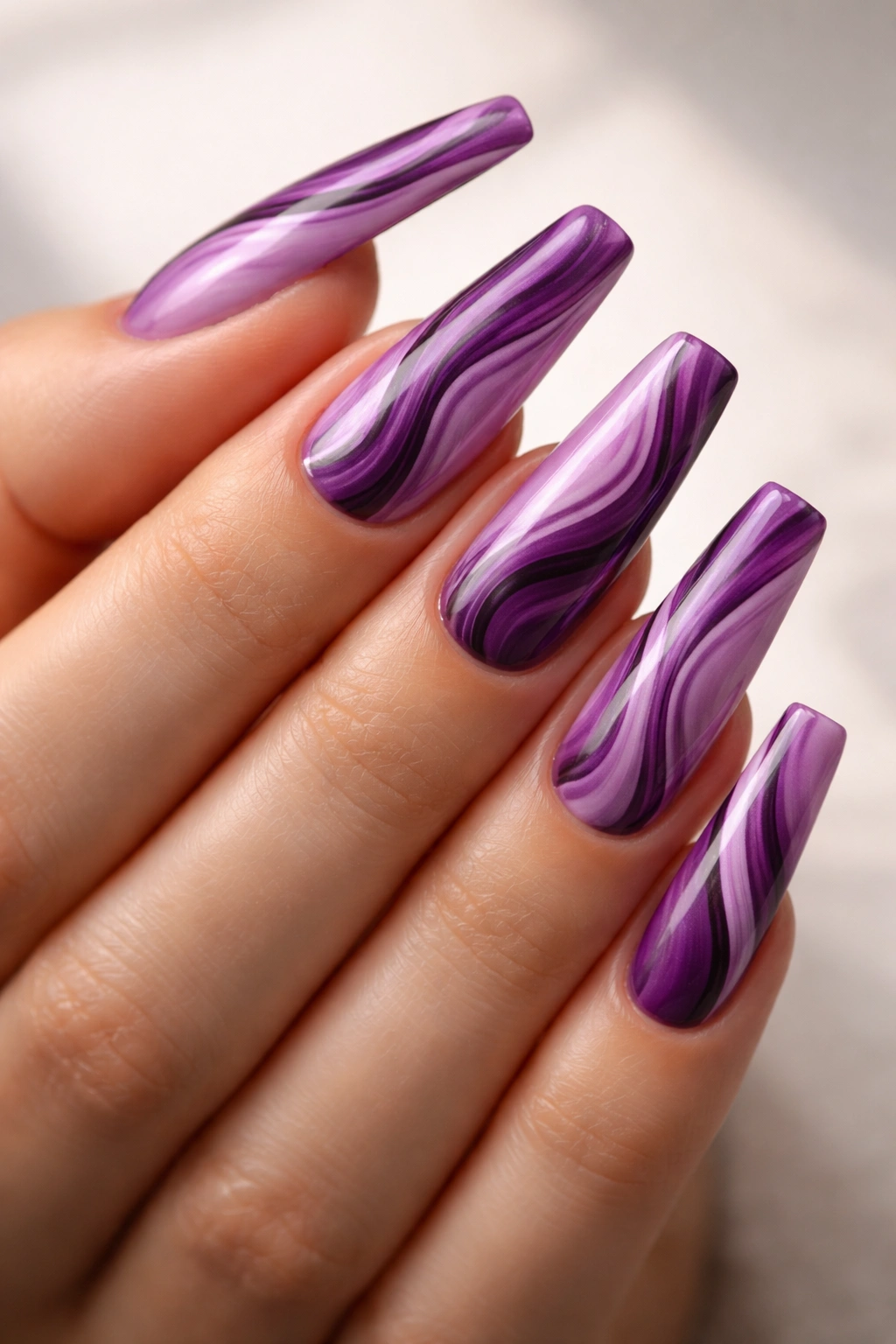 Berry swirl mani on coffin nails with purple tones
