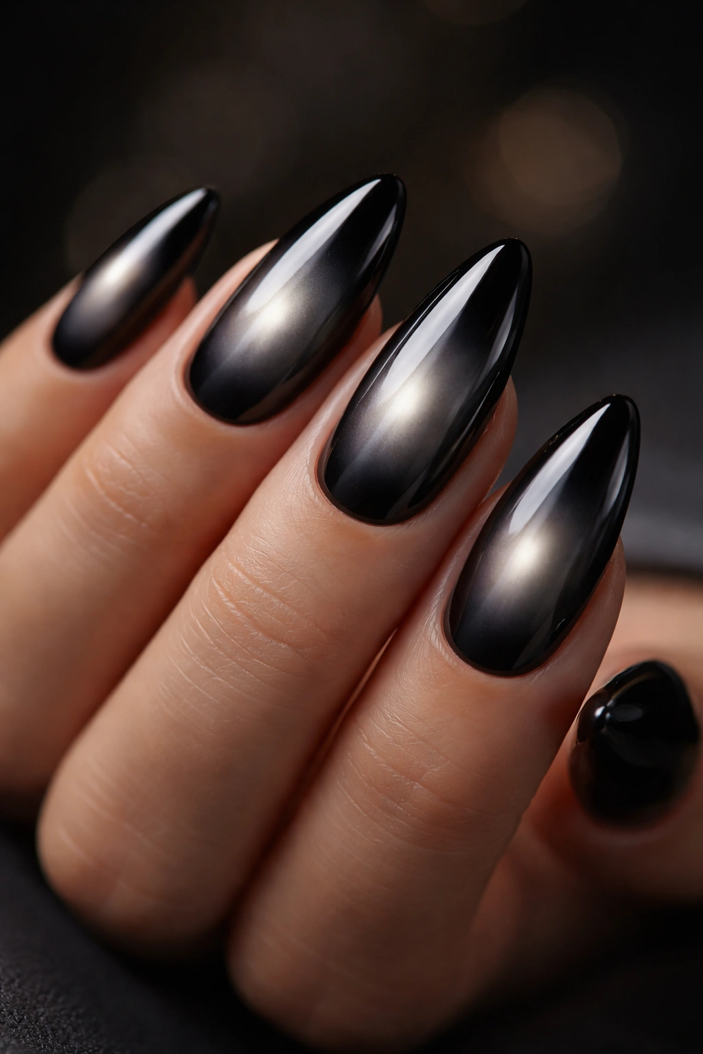 Almond nails with black chrome aura showing a soft diffused center glow