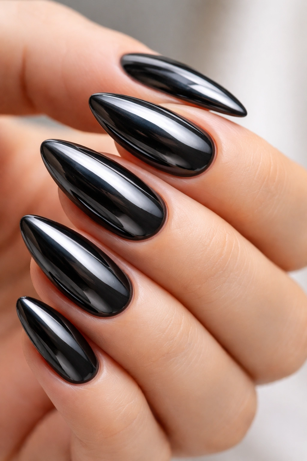 Almond nails with black chrome metallic finish