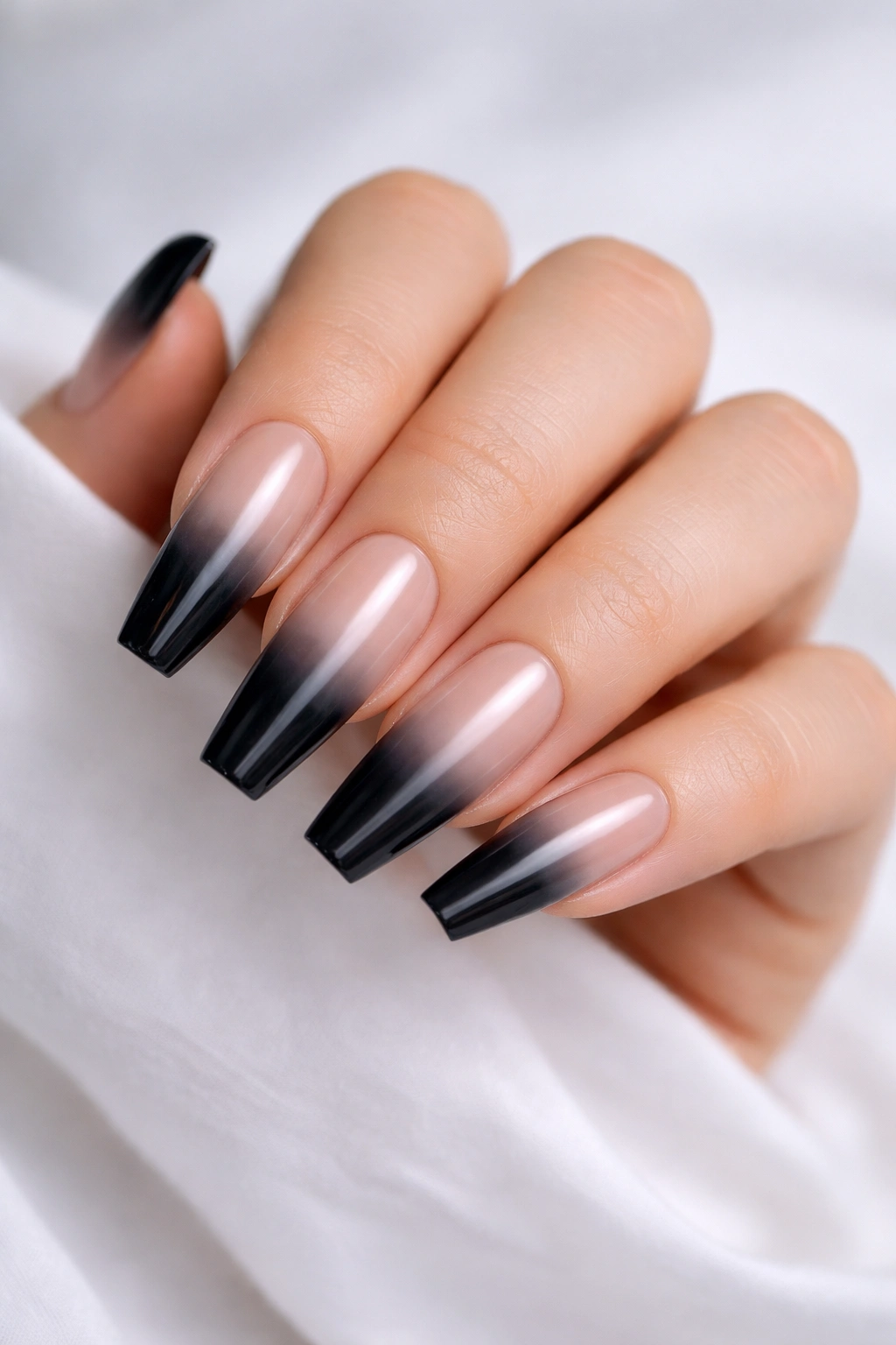 Close-up black to clear smoke ombre coffin nails with translucent gradient