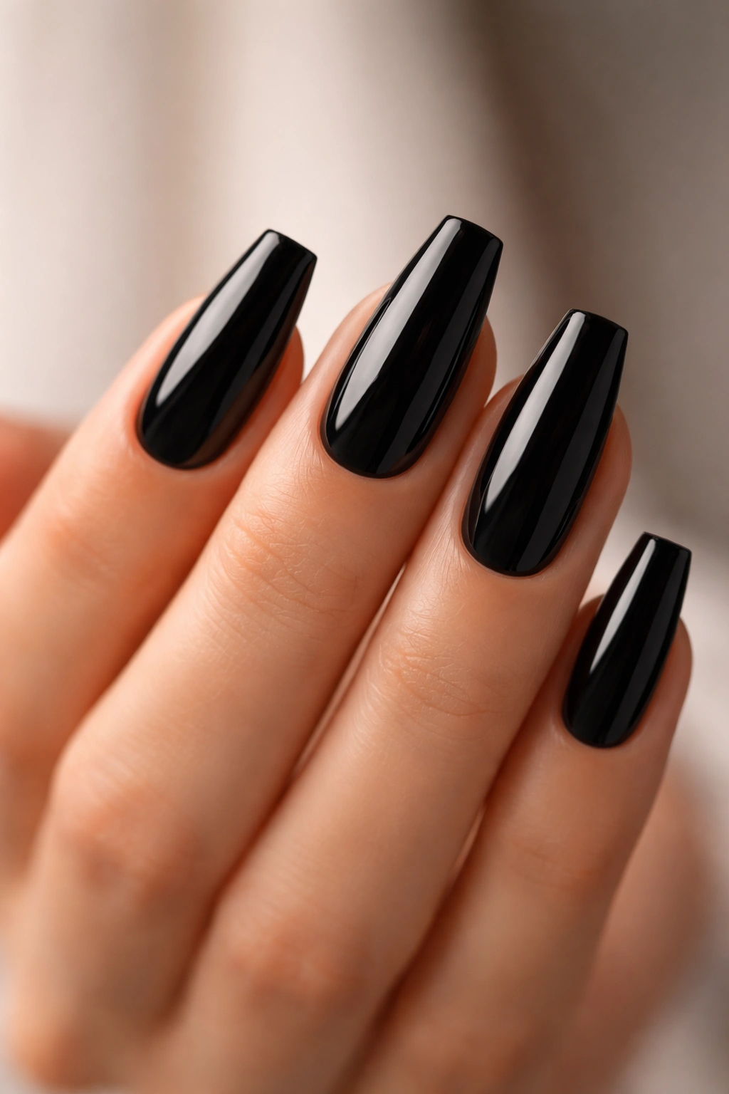 Close-up of medium-length black coffin nails with tapered sides and square tips
