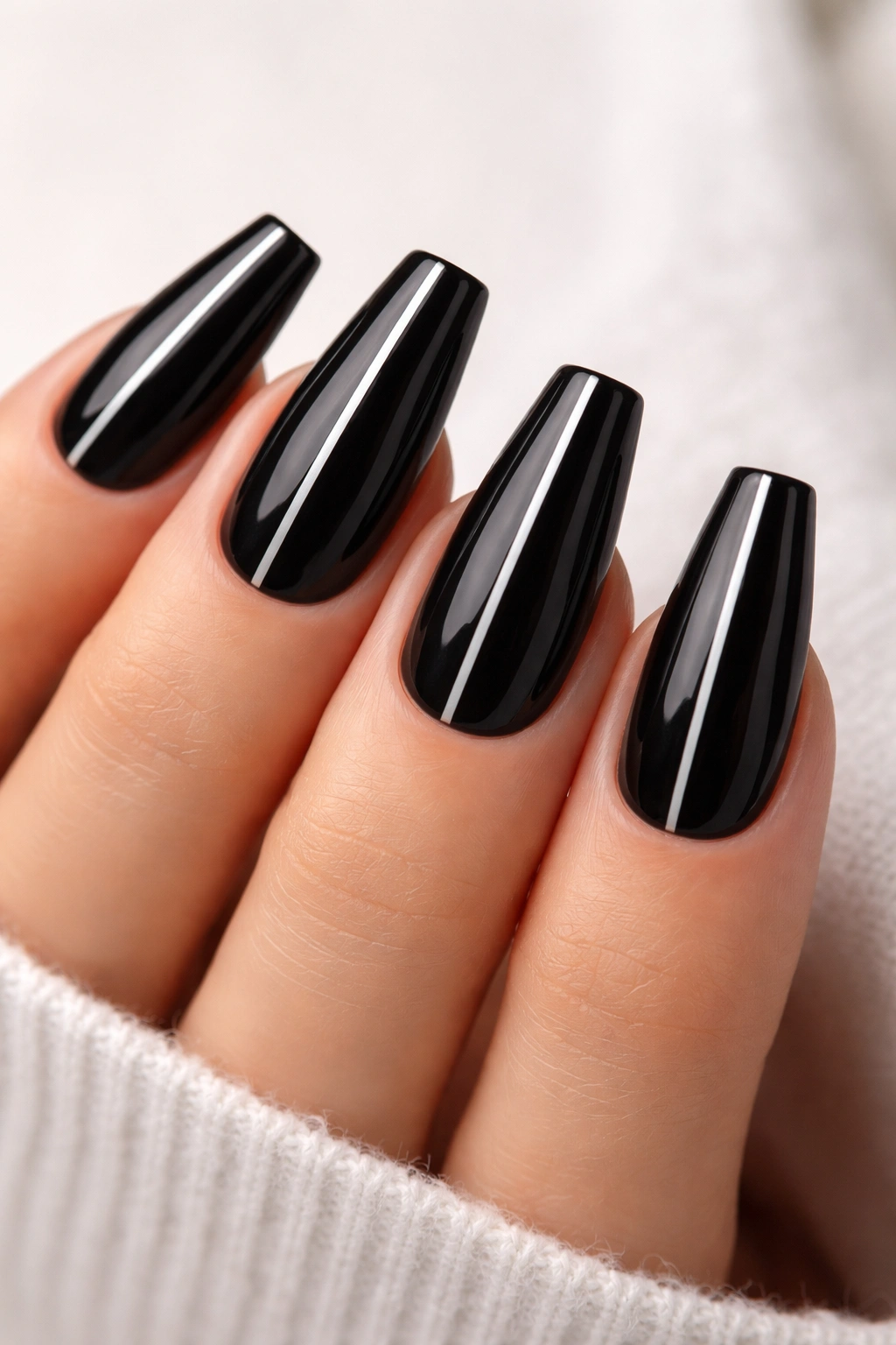 Black coffin nails with slim silver stripe close-up